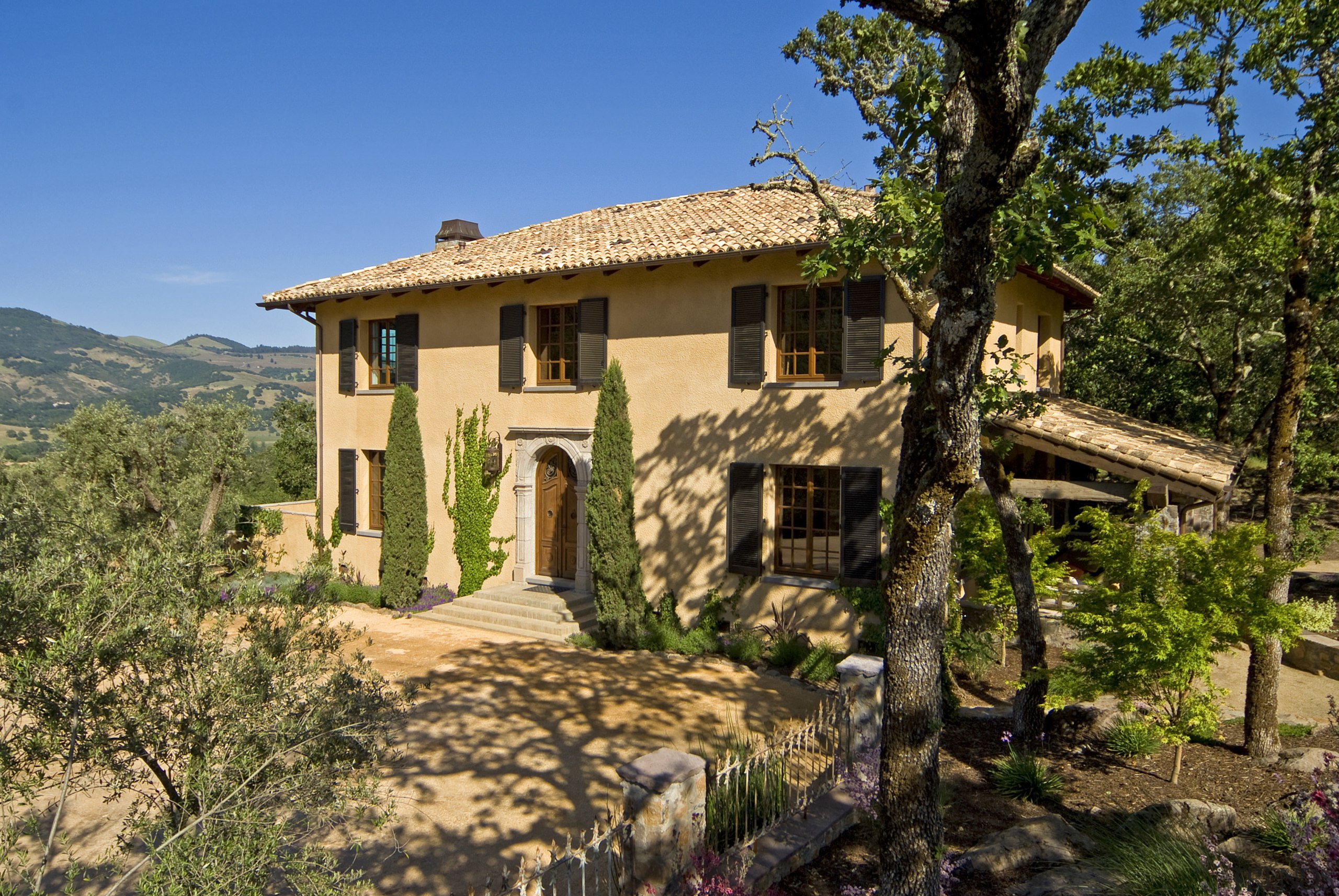 Grand entrance of this home - Grand entrance cottage, estate, hacienda, home, house, mountain, property, real estate, sky, tree, villa, brown