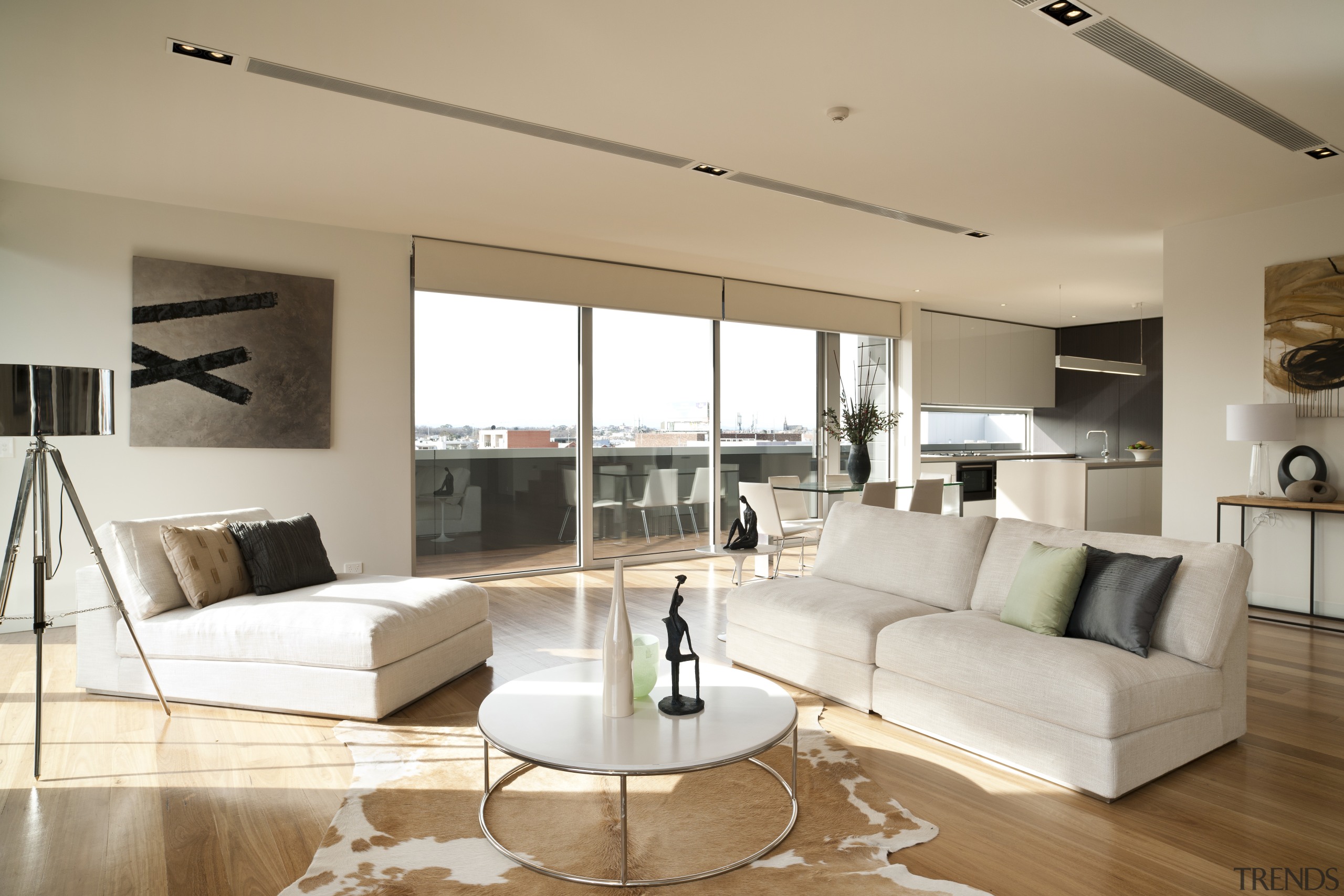 Penthouse living space with white couches, a circular ceiling, floor, flooring, furniture, hardwood, home, interior design, interior designer, living room, property, real estate, room, wall, window, wood, wood flooring, white, orange