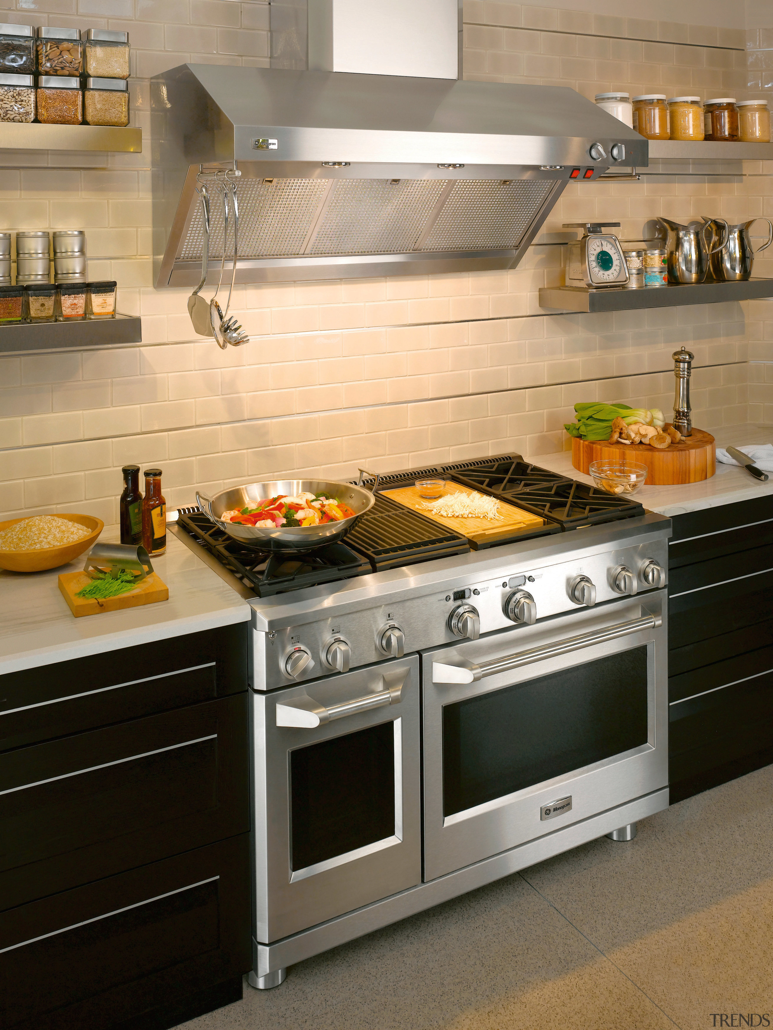 View of a kitchen which features a range, countertop, gas stove, home appliance, kitchen, kitchen appliance, kitchen stove, oven