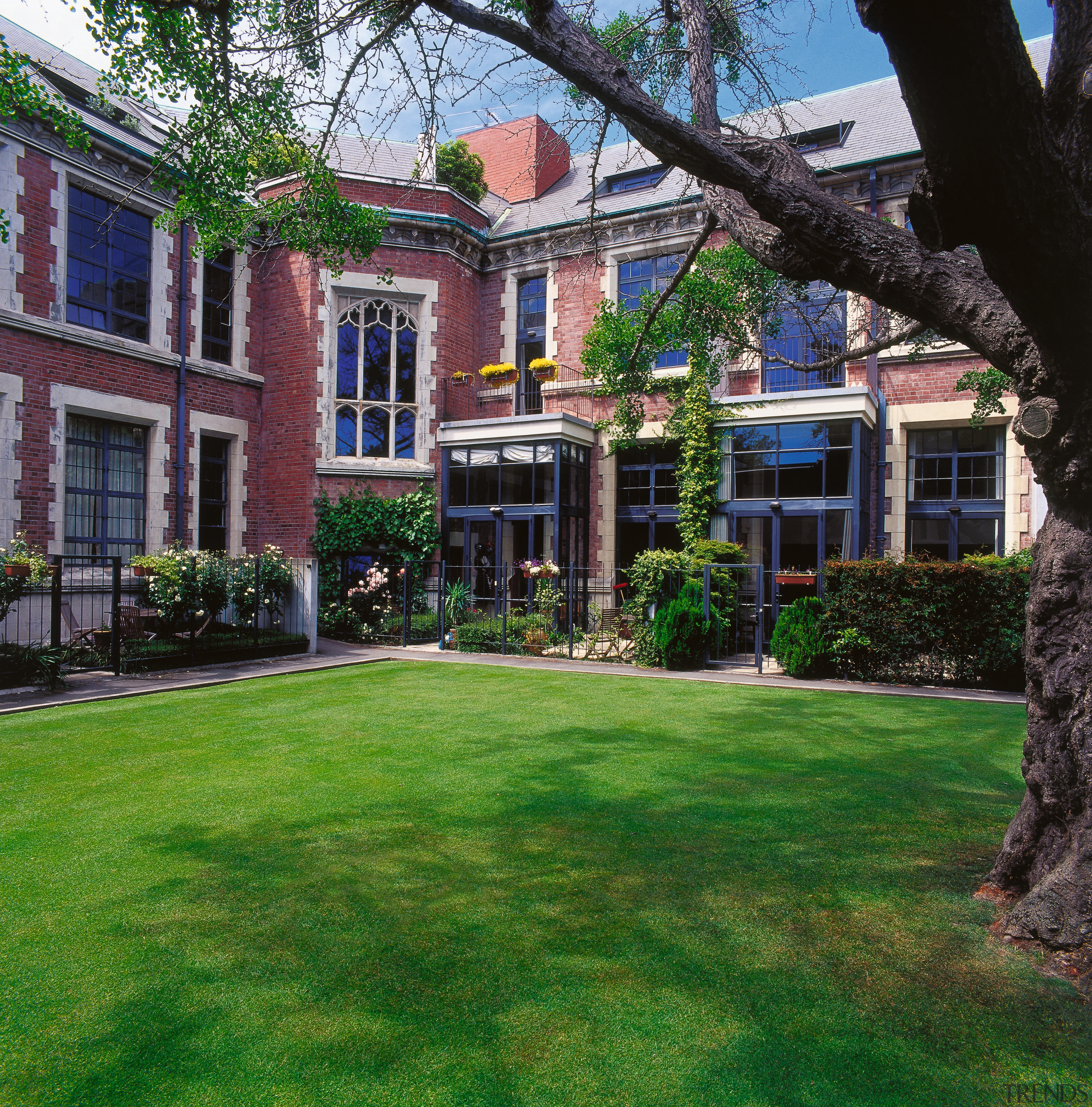 A view of the Peterborough Apartments,  architect architecture, backyard, building, cottage, courtyard, estate, facade, garden, grass, historic house, home, house, landscaping, lawn, mansion, neighbourhood, plant, plantation, property, real estate, residential area, tree, window, yard, green