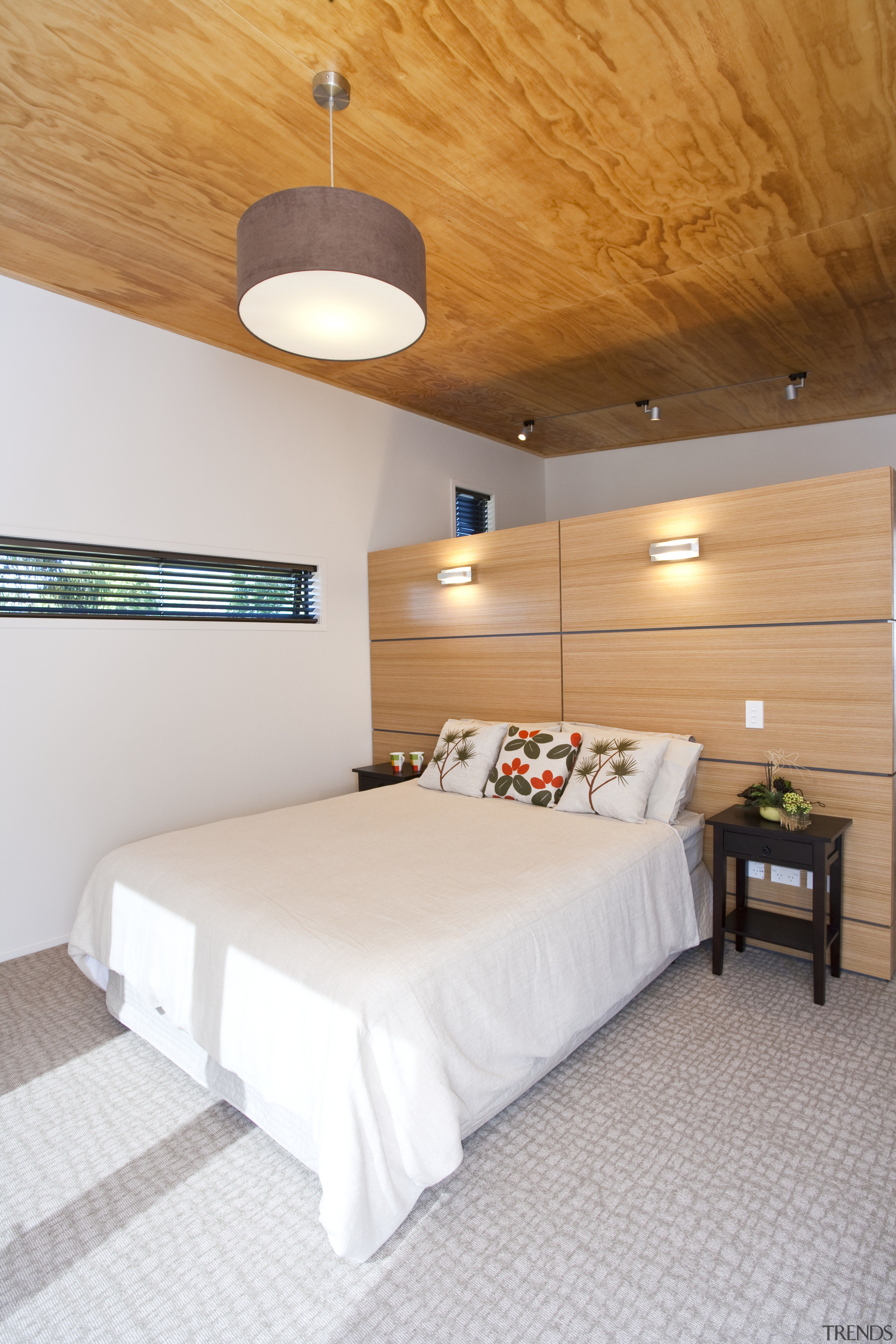 view of bedroom which features carpeted floors, lighting architecture, bed frame, bedroom, ceiling, daylighting, floor, flooring, furniture, hotel, interior design, real estate, room, suite, wood, gray, orange