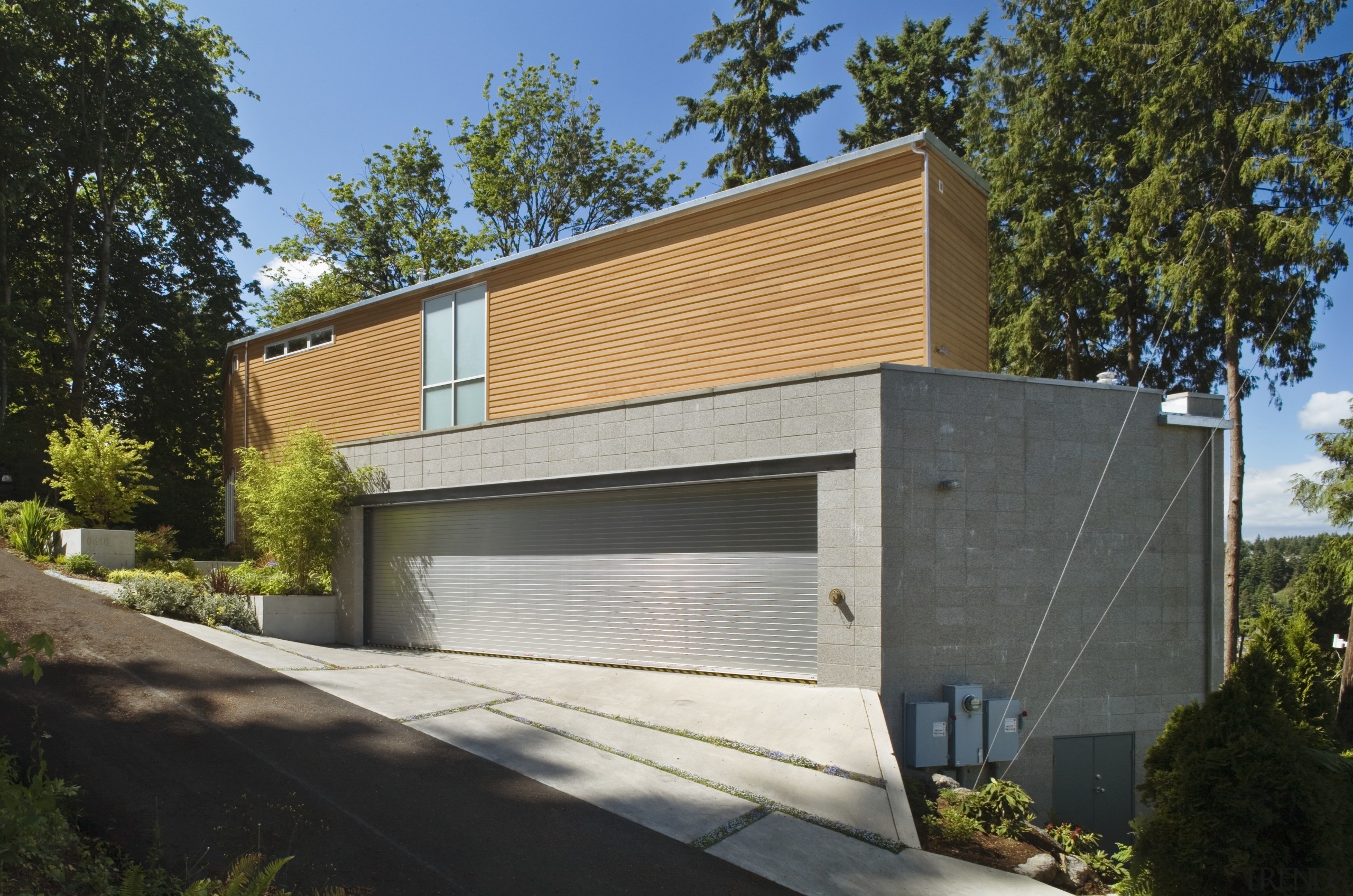 The mid-level garage extends beyond the triangular footprint architecture, building, elevation, facade, home, house, property, real estate, residential area, siding, brown, gray, black