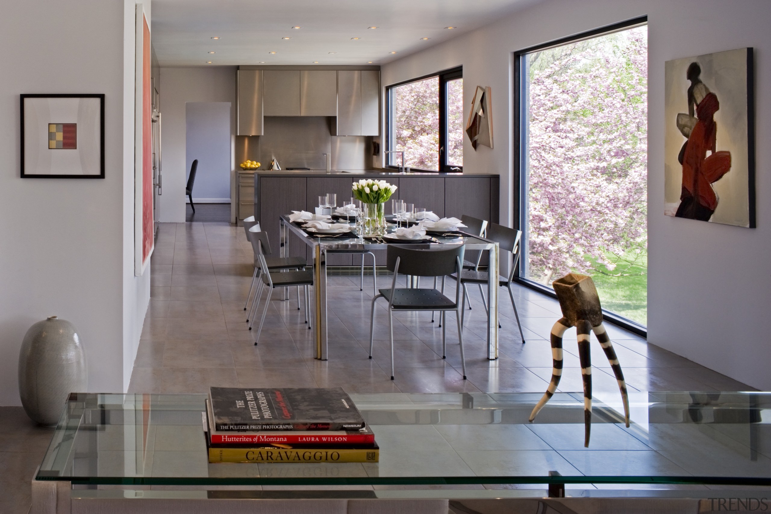 View of the open-plan kitchen and dining area dining room, floor, furniture, home, house, interior design, living room, room, table, gray