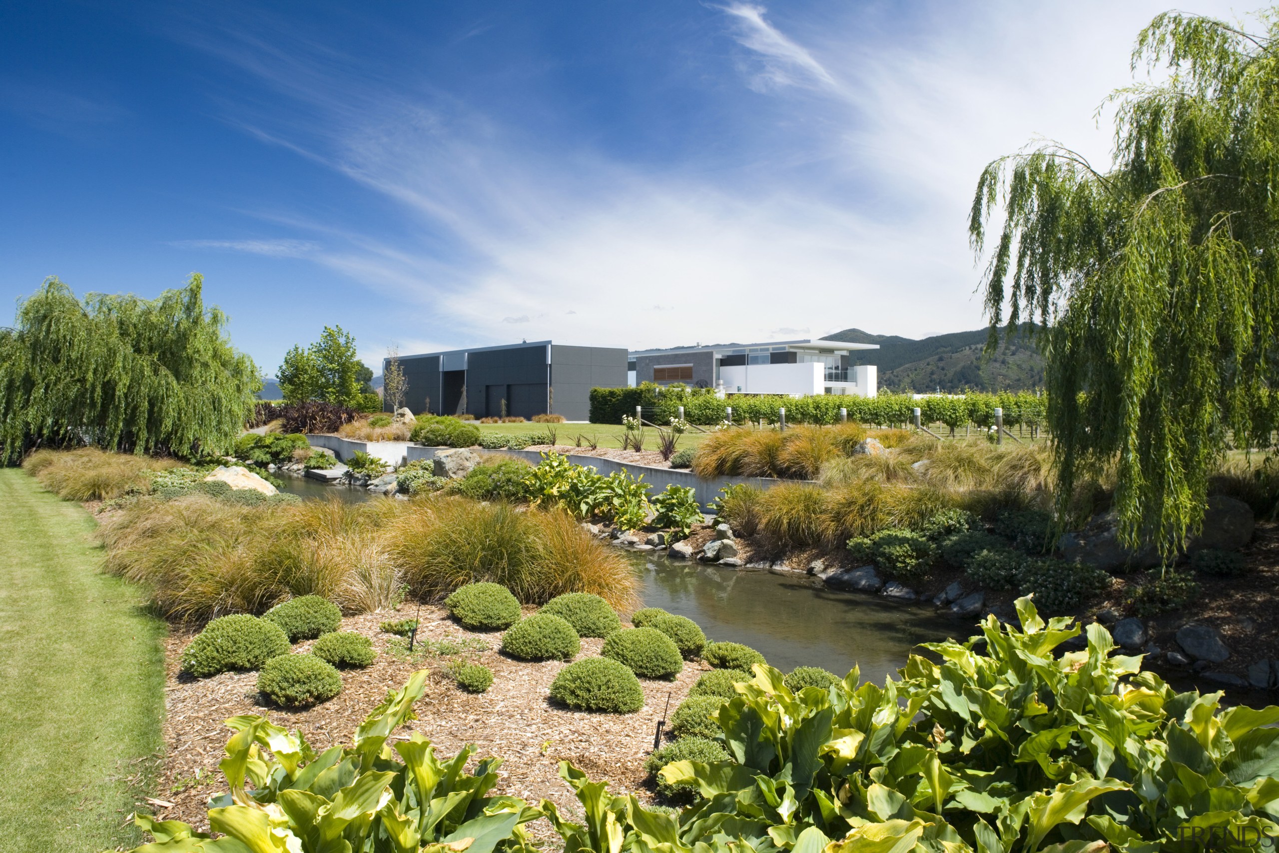 An exterior view of the entire home and botanical garden, estate, garden, grass, landscape, landscaping, nature, plant, real estate, sky, tree, vegetation, water, brown