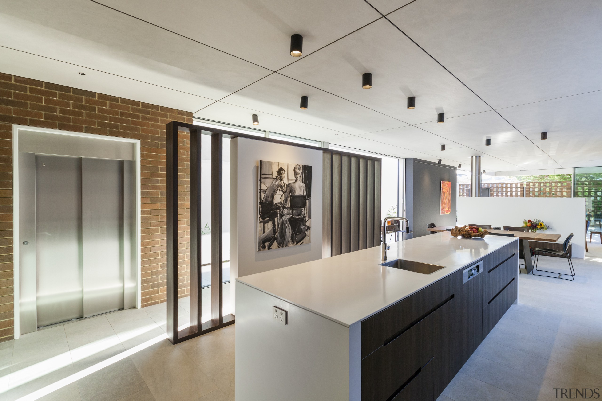 ​​​​​​​This minimalist kitchen has recessed cabinet handles while architecture, countertop, house, interior design, kitchen, real estate, gray