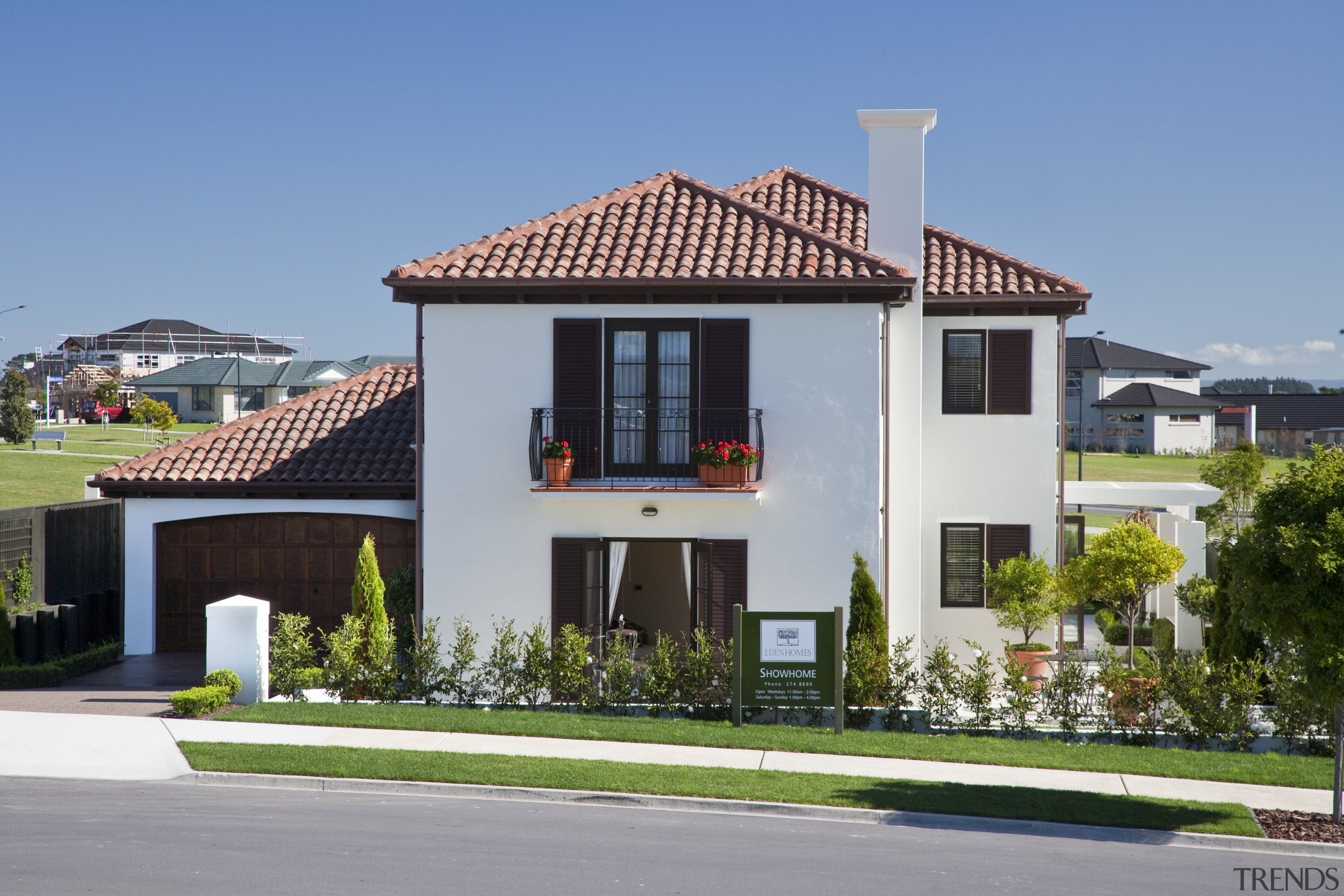 Exterior view of Eden Homes show home which apartment, building, elevation, estate, facade, home, house, mansion, neighbourhood, official residence, property, real estate, residential area, roof, sky, suburb, villa, teal