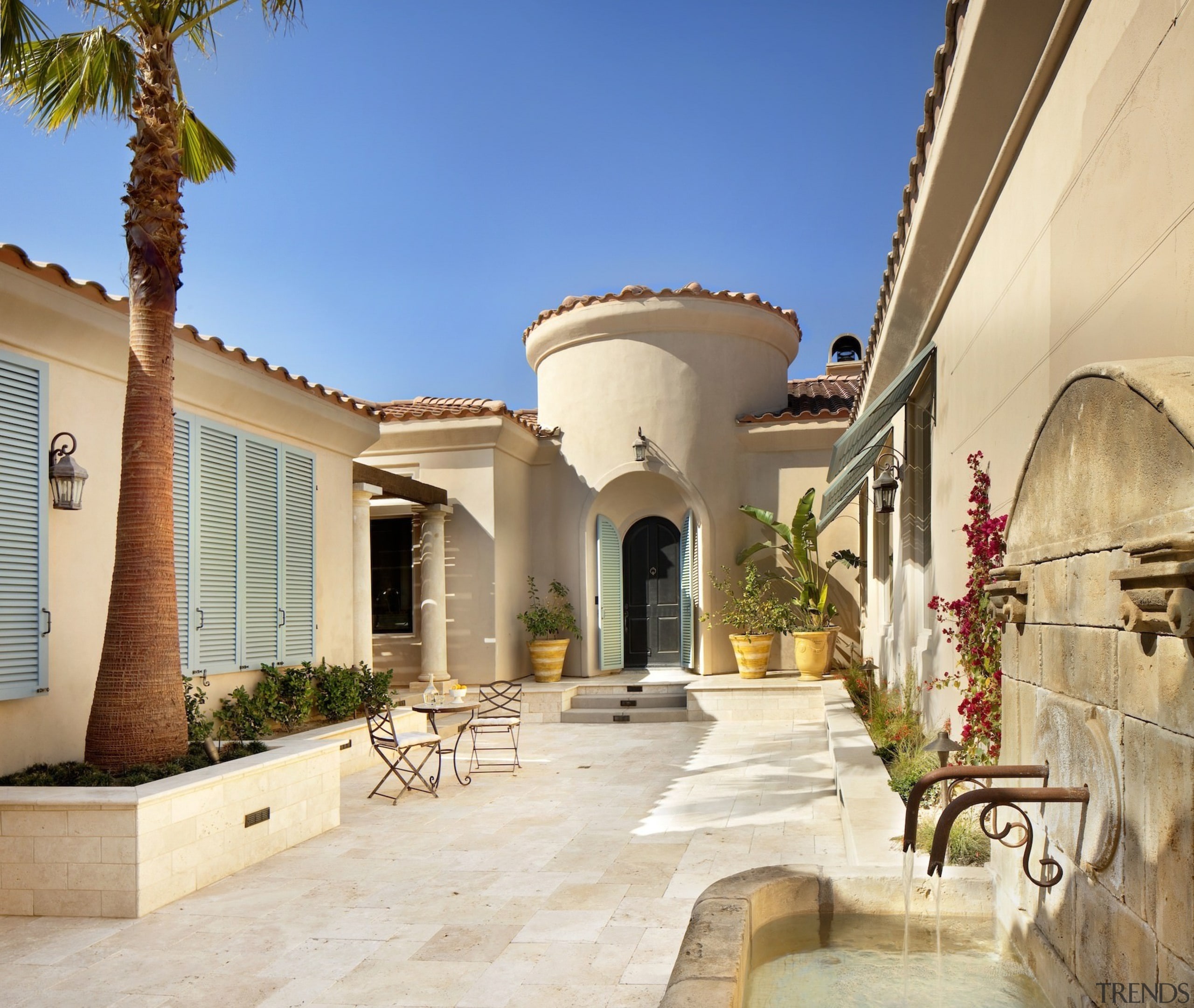 A private courtyard features potted plants and a courtyard, estate, hacienda, home, house, mansion, property, real estate, residential area, villa, orange