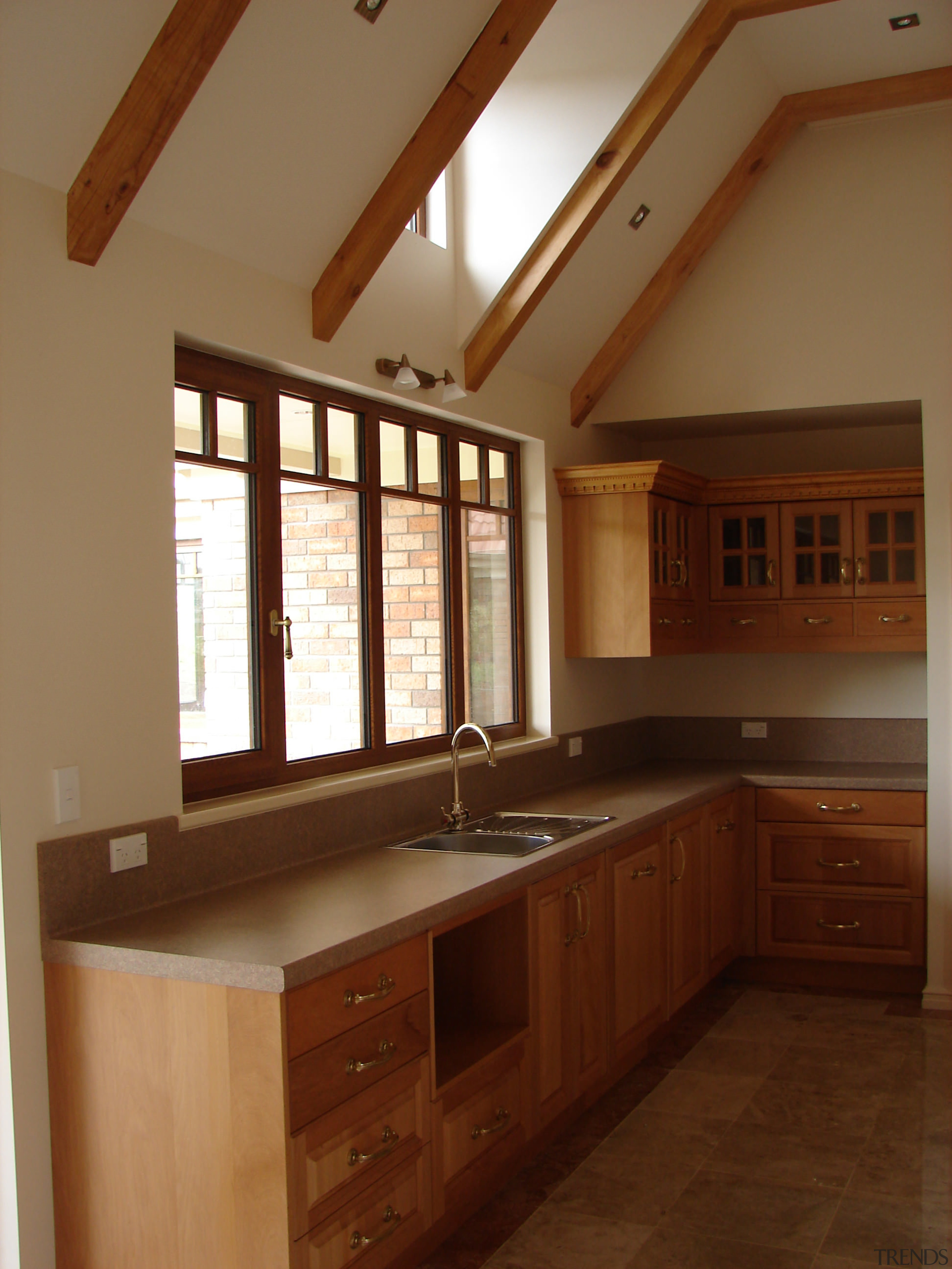 View of cabinetry by Classwood doors - View cabinetry, ceiling, countertop, cuisine classique, daylighting, floor, flooring, hardwood, home, interior design, kitchen, real estate, room, under cabinet lighting, window, wood, wood flooring, wood stain, brown