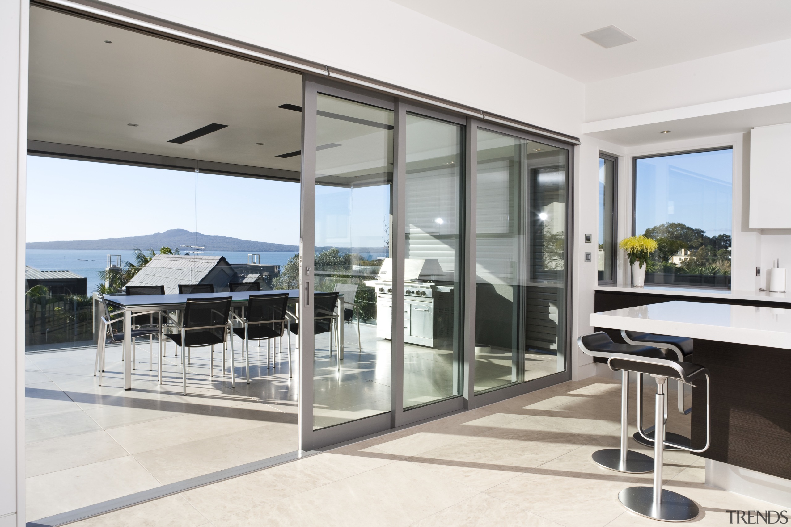 View of a house which features aluminium joinery daylighting, door, floor, flooring, glass, house, interior design, property, real estate, window, white, gray