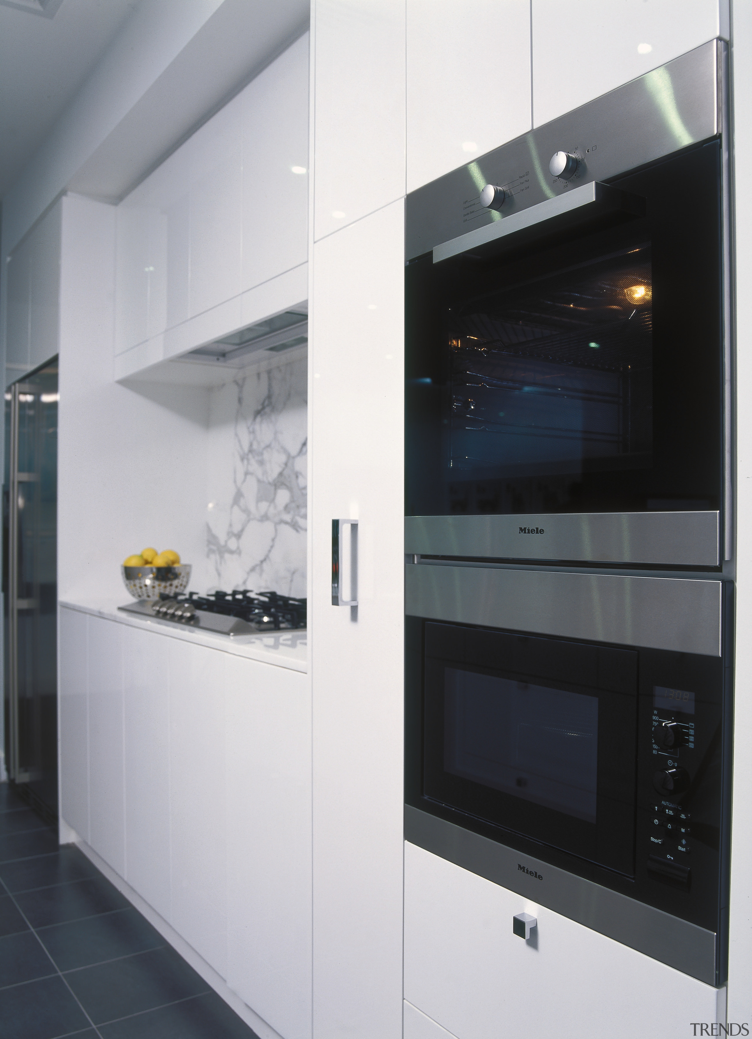 Kitchen with white cabinetry, showing multifunction wall oven. countertop, home appliance, interior design, kitchen, kitchen appliance, major appliance, oven, gray, black