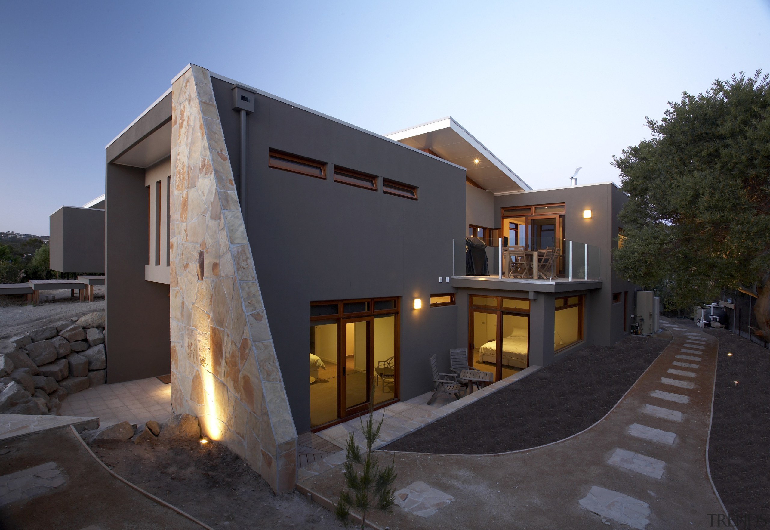 Exterior view of a family home designed and architecture, building, estate, facade, home, house, lighting, property, real estate, residential area, window, black