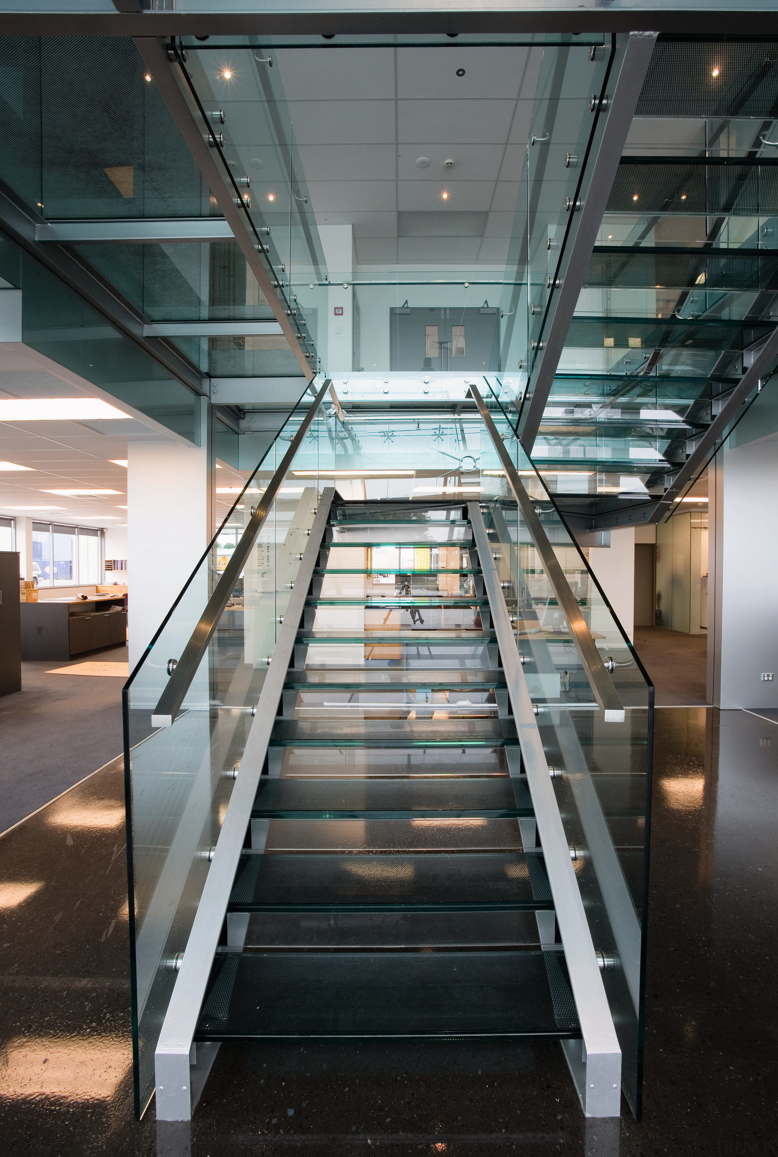 Staircase in office, with glass balustrades, landings and architecture, building, daylighting, glass, handrail, stairs, structure, black, gray