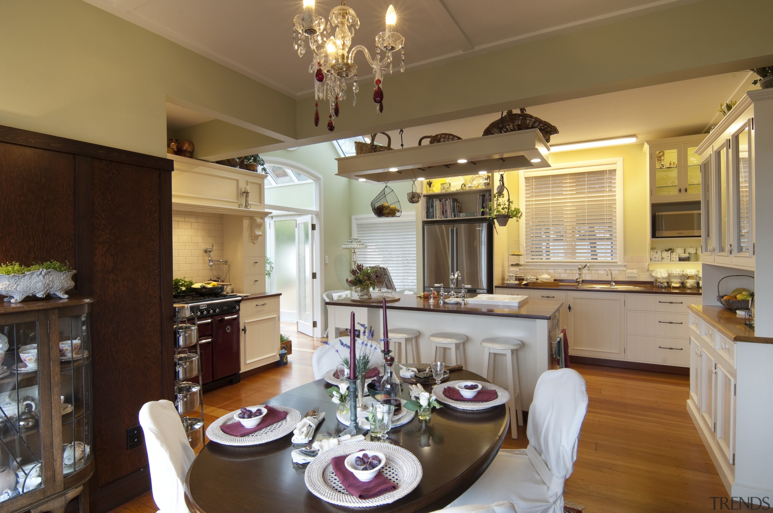 oval dining table with whtie chairs and plates. countertop, cuisine classique, dining room, home, interior design, kitchen, living room, real estate, room, brown