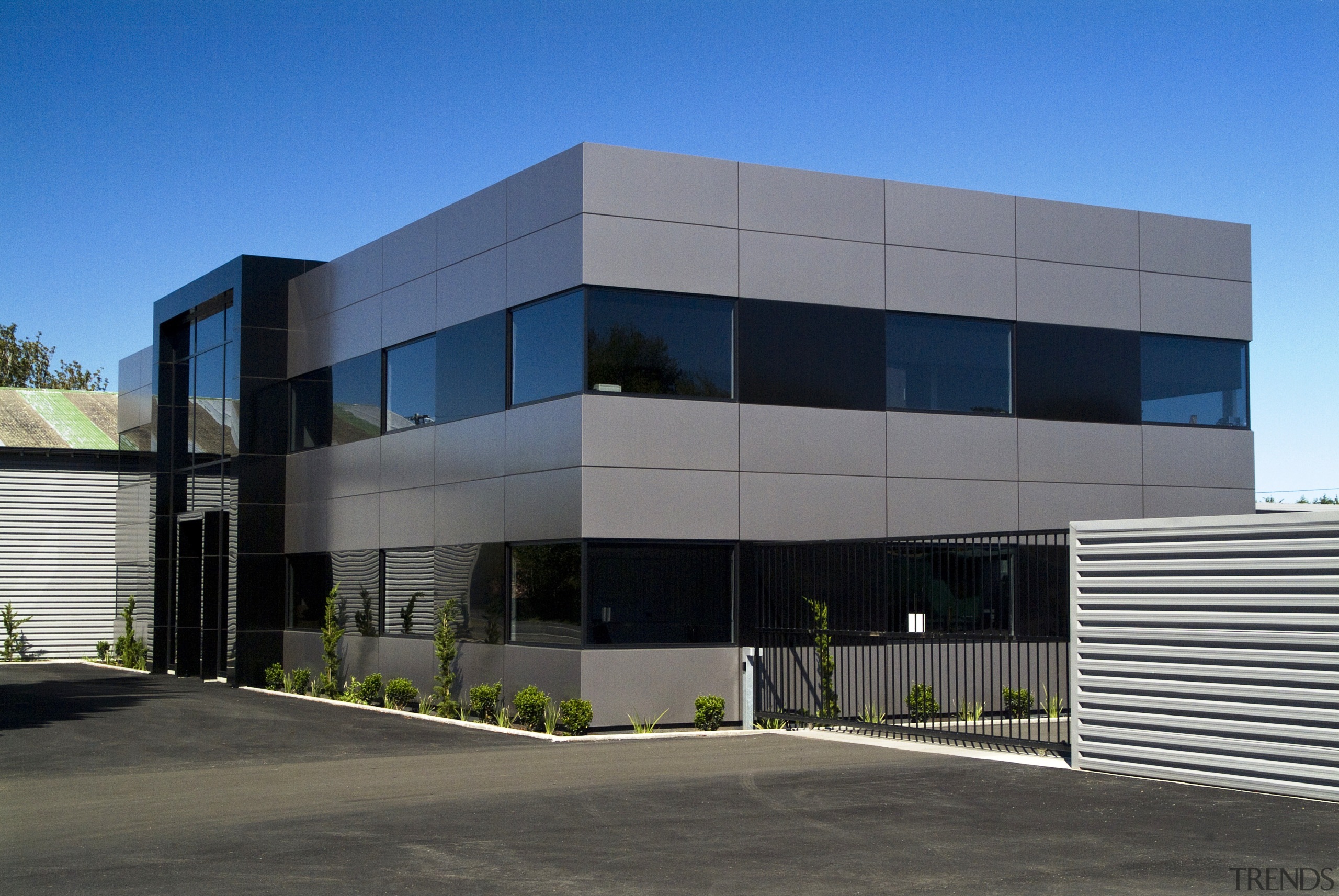 Exterior view of the office building - Exterior architecture, building, commercial building, corporate headquarters, elevation, facade, headquarters, house, property, real estate, residential area, sky, gray, teal