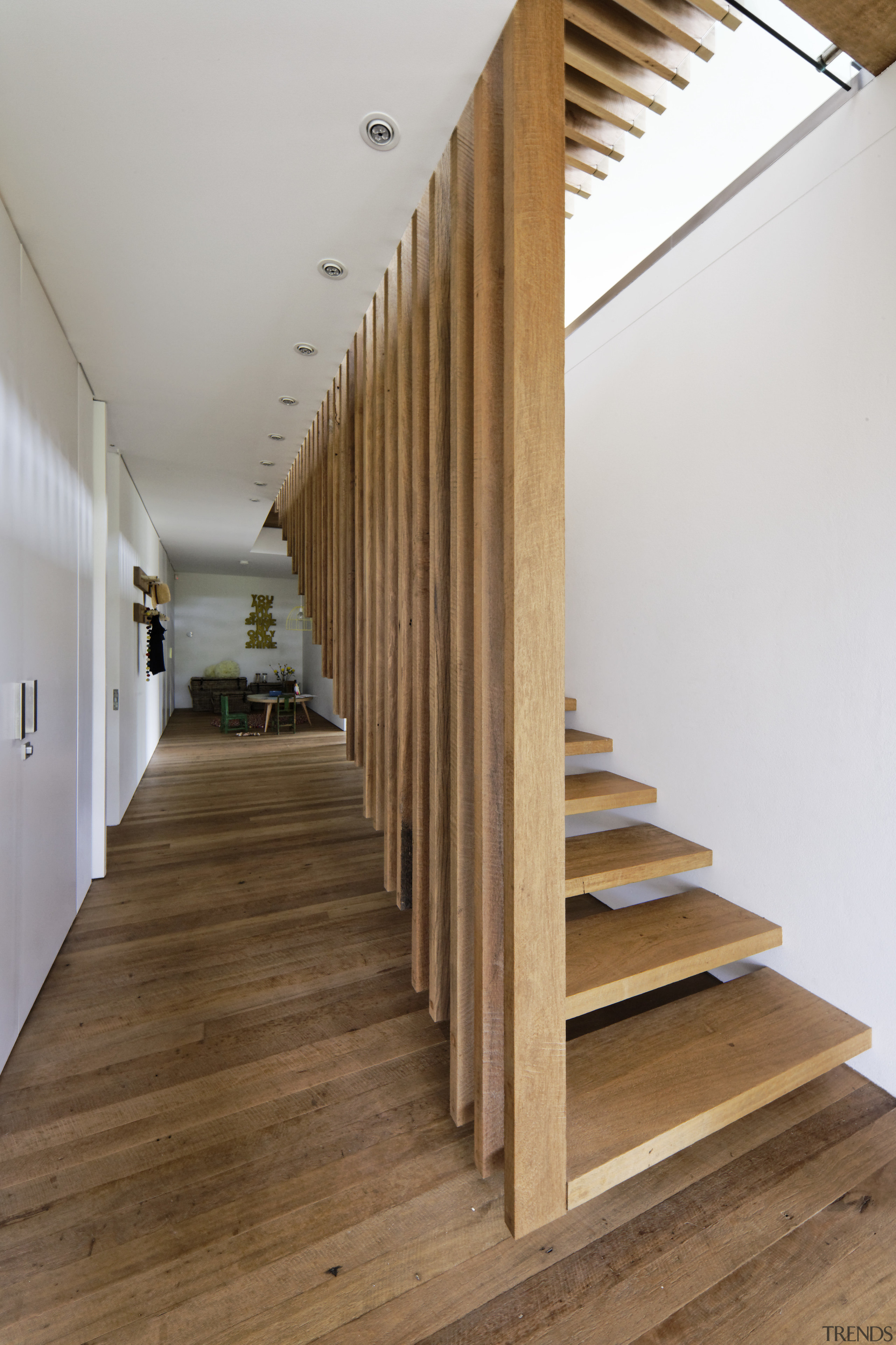 Slats from the kitchen island above extend down architecture, daylighting, floor, flooring, handrail, hardwood, house, interior design, laminate flooring, stairs, wood, wood flooring, brown, gray