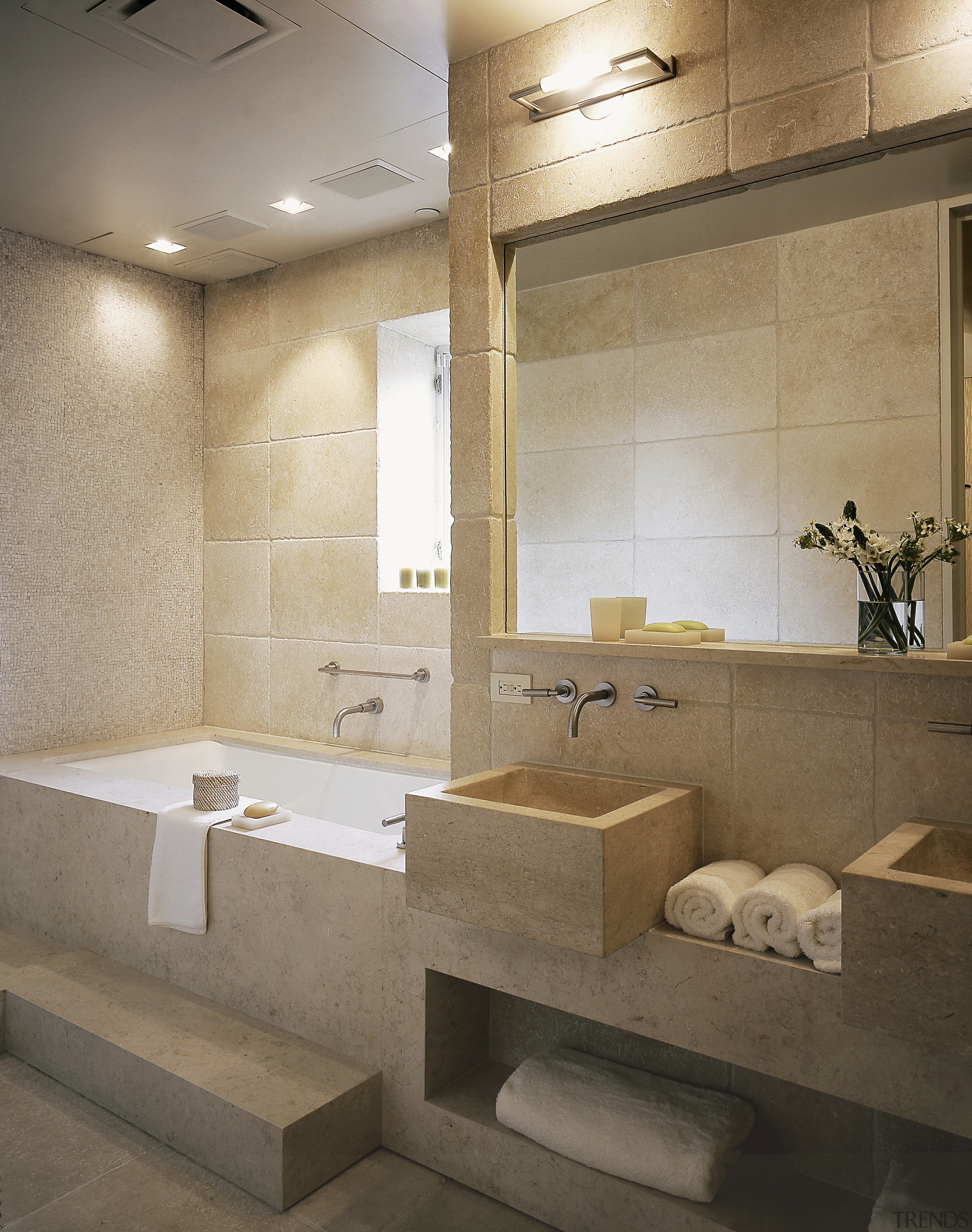 View of this bathroom featuring two seater bathtub, architecture, bathroom, ceiling, floor, flooring, interior design, plumbing fixture, room, sink, tile, wall, gray, brown