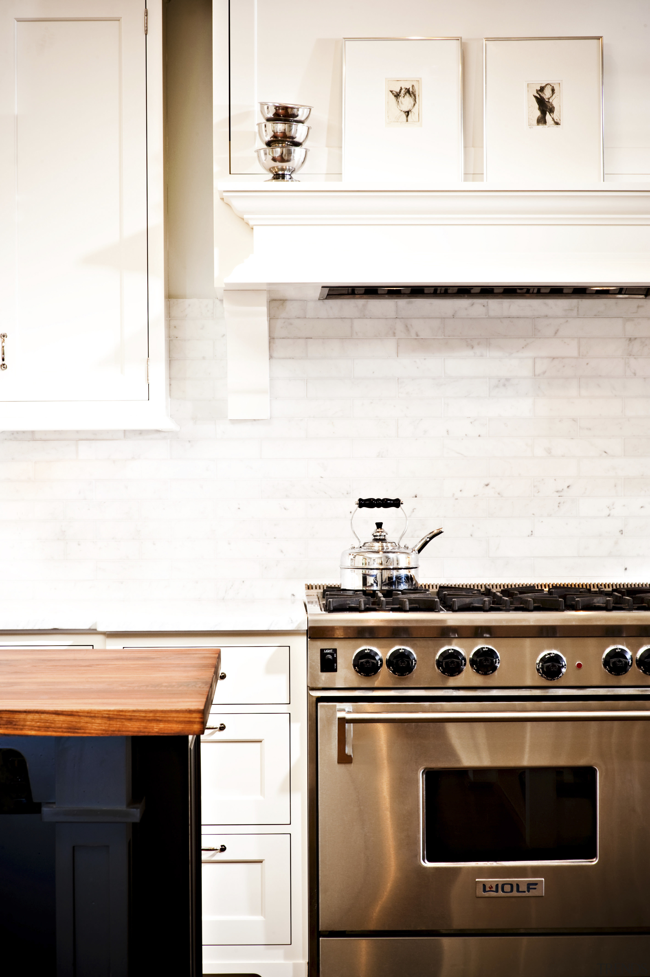 View of kitchen designed by Nadia Subaran. Designed cabinetry, countertop, floor, flooring, furniture, hardwood, home, home appliance, interior design, kitchen, kitchen stove, room, under cabinet lighting, white