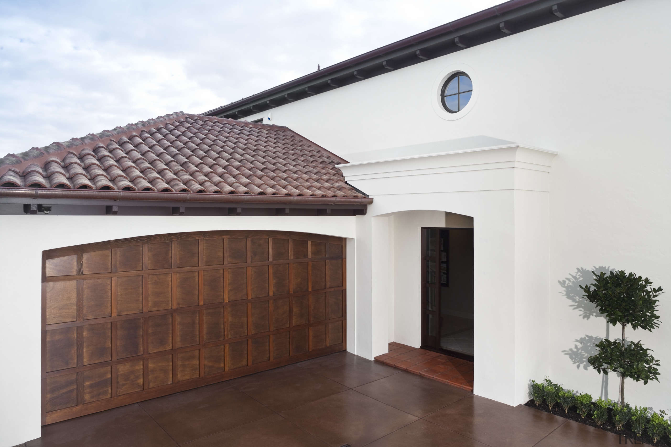 Exterior view of Eden Homes show home which daylighting, door, estate, facade, garage door, home, house, property, real estate, roof, white, red