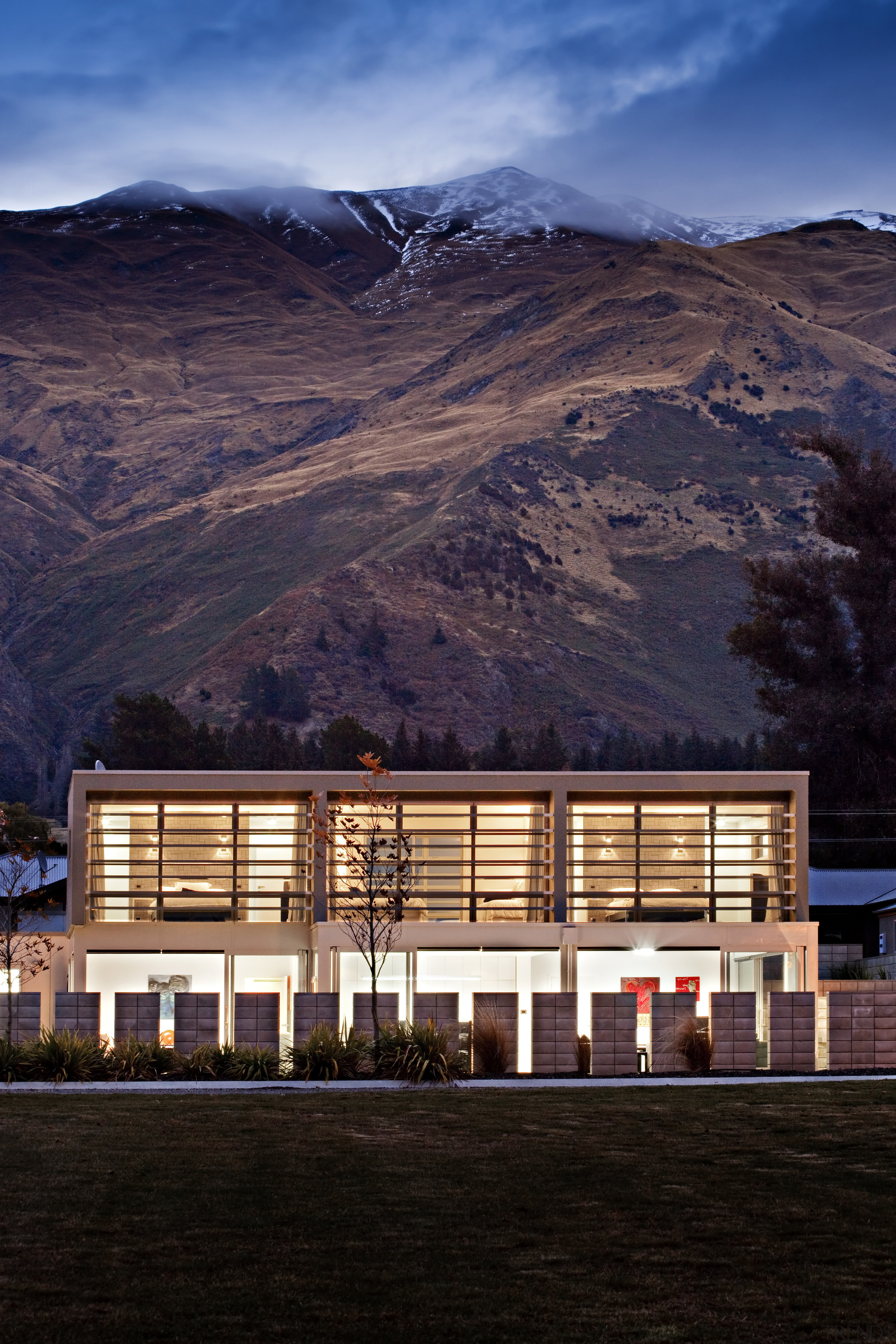 View of the homes exterior featuring plaster and architecture, building, cloud, elevation, evening, facade, home, house, landscape, morning, mountain, mountain range, real estate, reflection, residential area, sky, black