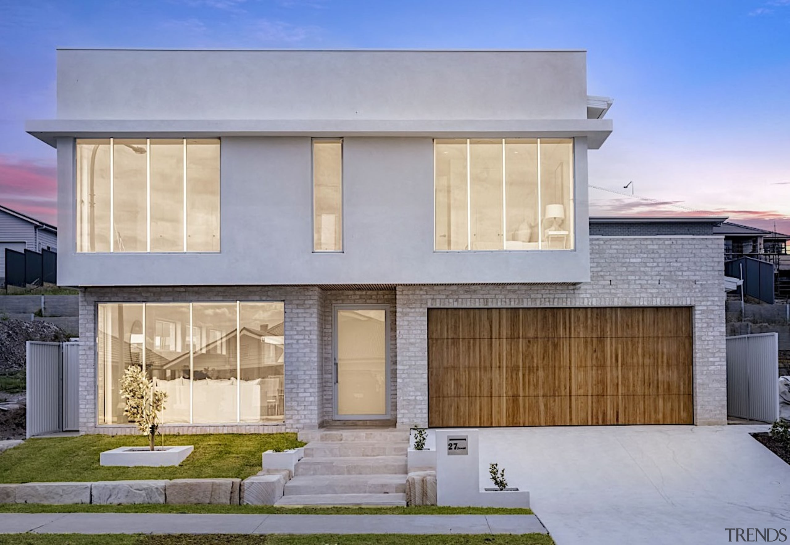 Front facade with wood-fronted garage door contrasting the 