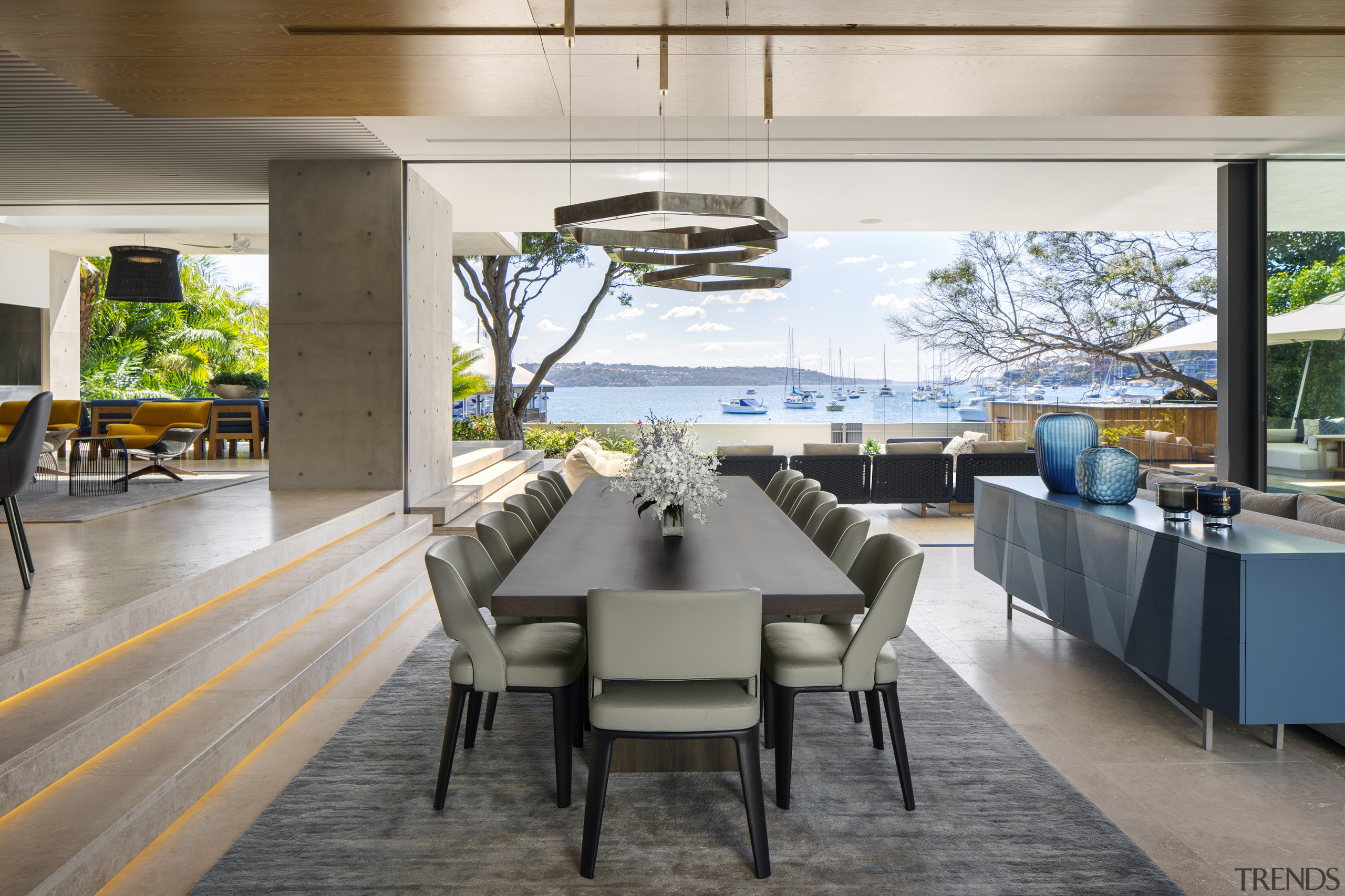 ​​​​​​​Stairs rather than walls delineate the raised kitchen architecture, dining room, interior design, dining table, furniture, timber floor,  SAOTA, travertine