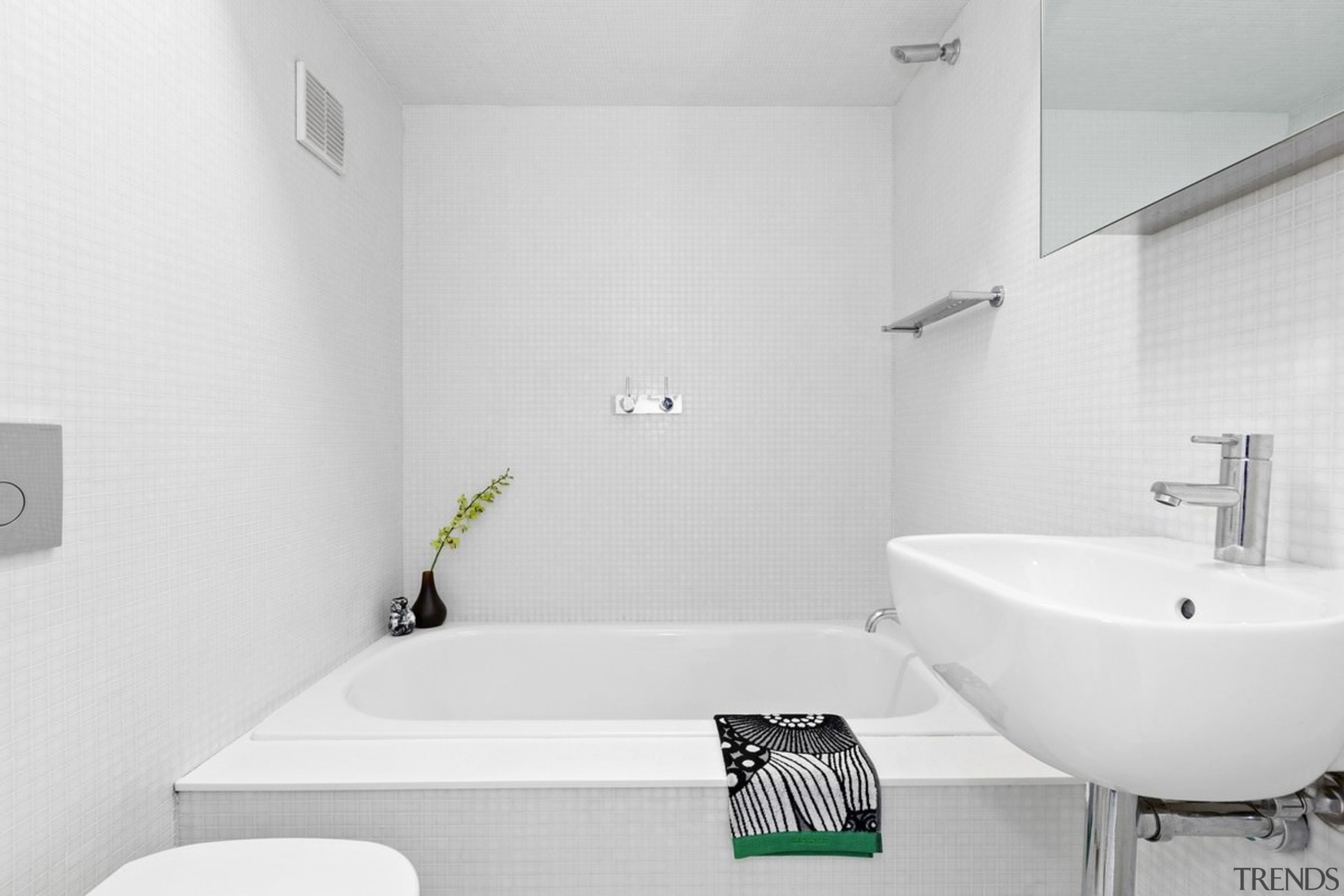 A large bathtub dominates the bathroom - A architecture, bathroom, bathroom sink, bidet, black and white, floor, house, interior design, plumbing fixture, product design, property, room, tap, tile, wall, white