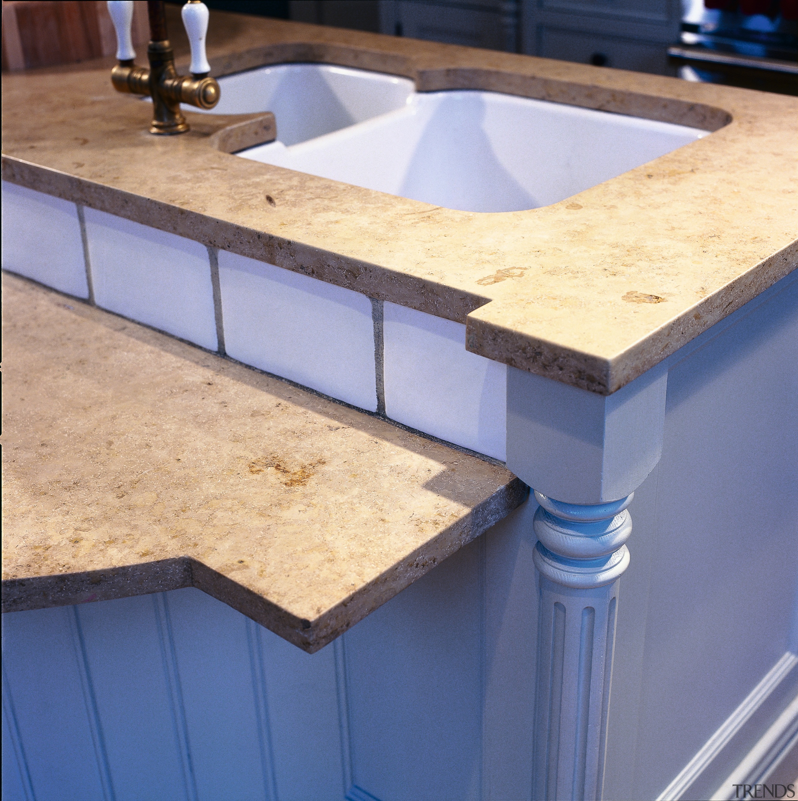 A view of this kitchen that features a countertop, material, sink, wood stain, blue, orange