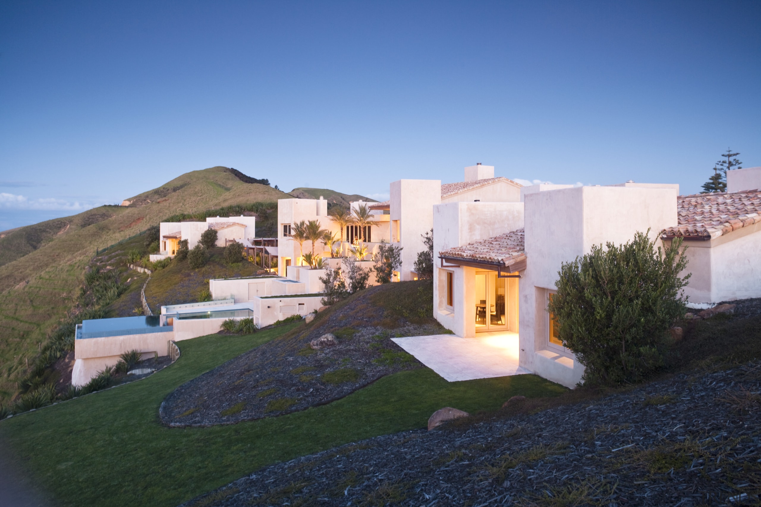 Exterior view of Mediterranean styled house which is cottage, estate, home, house, property, real estate, residential area, sky, villa, teal