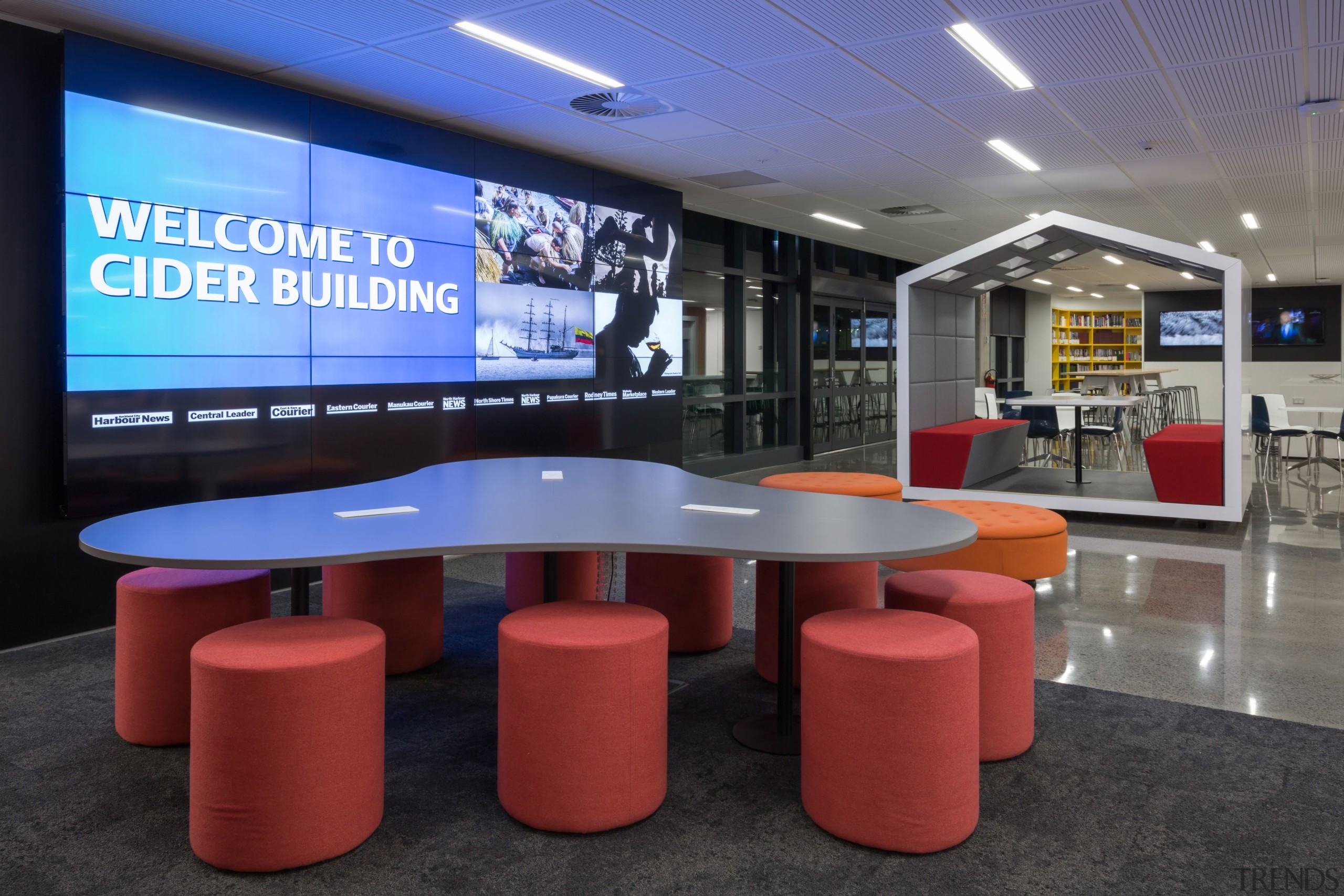 This large, curvaceous meeting table is fully wired display device, interior design, black