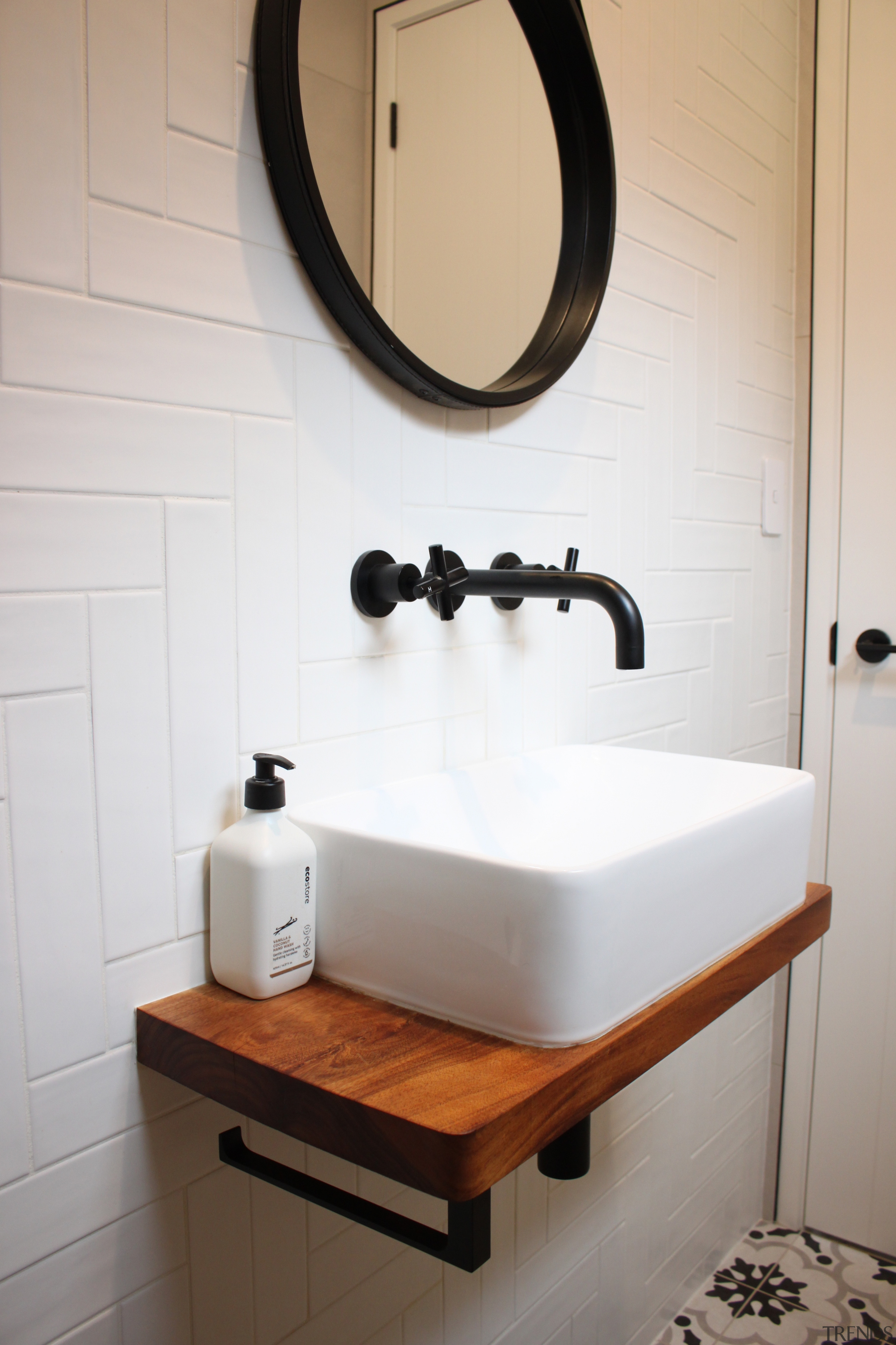 The powder room features a Victoria White Satin 
