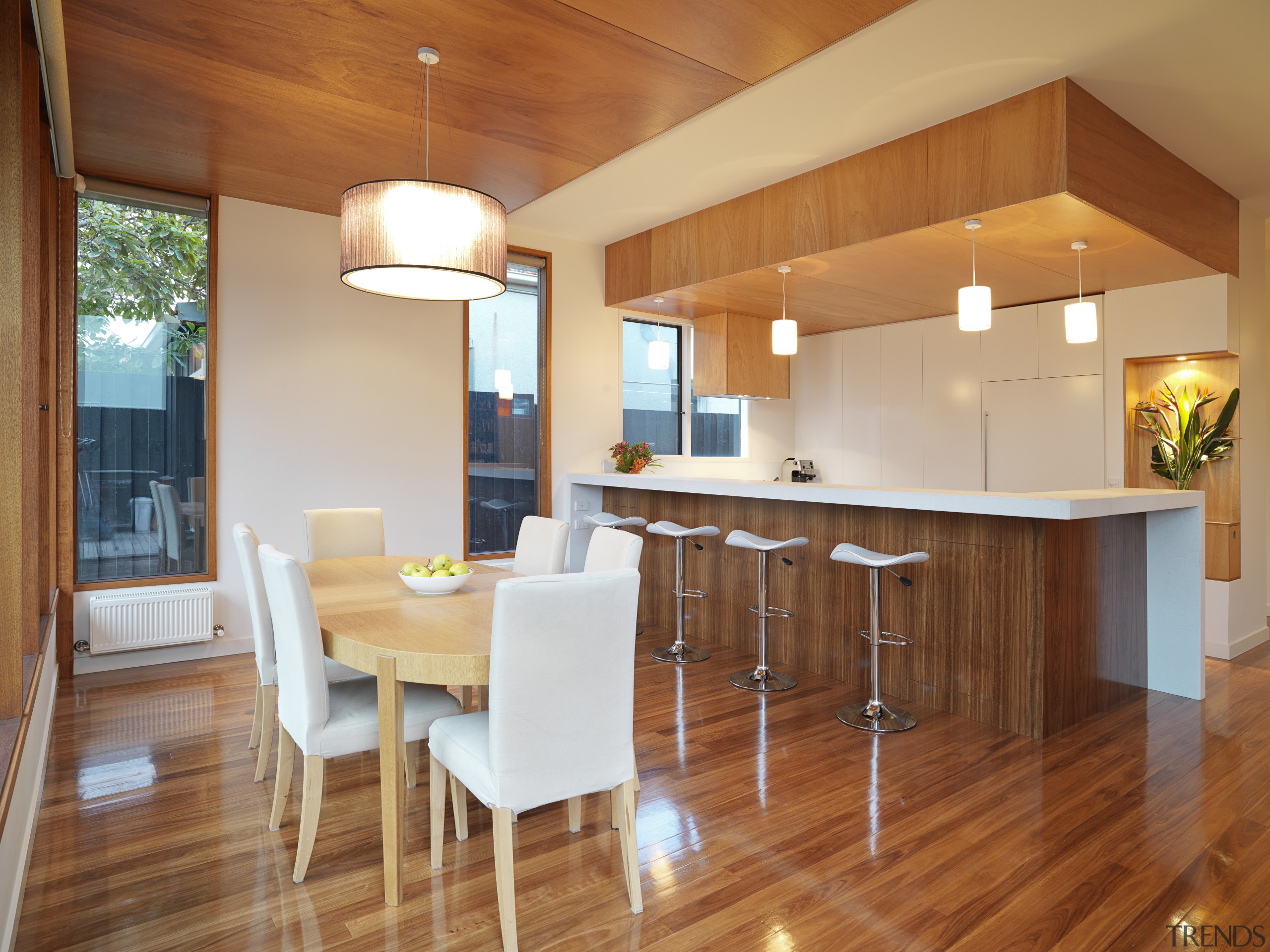 View of open-plan kitchen and dining area featuring ceiling, countertop, dining room, floor, flooring, hardwood, home, house, interior design, kitchen, laminate flooring, real estate, room, table, wood, wood flooring, brown, orange