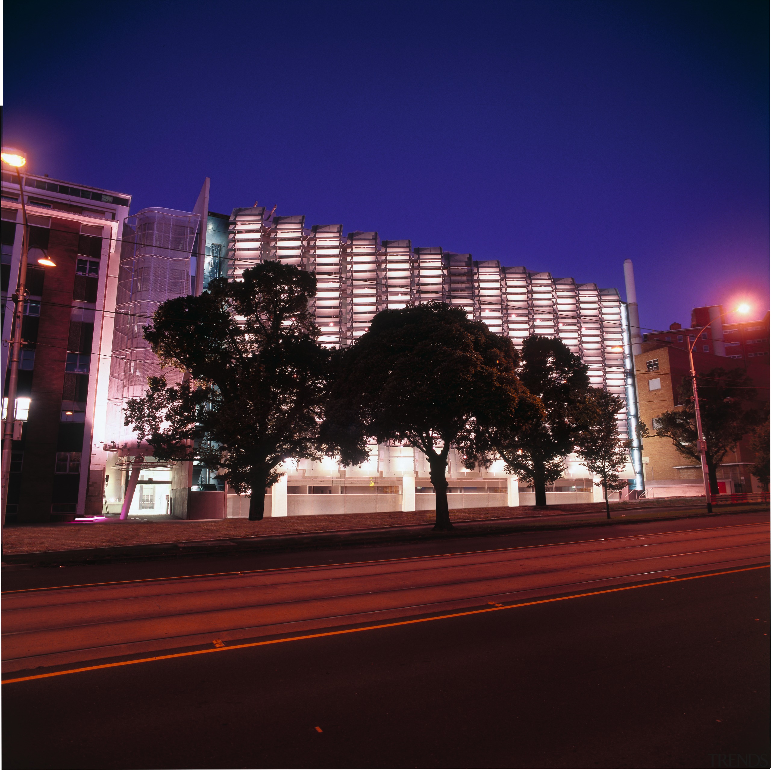 Exterior view of research centre building showing glass architecture, building, city, cityscape, daytime, downtown, dusk, evening, facade, infrastructure, landmark, light, lighting, metropolis, metropolitan area, night, reflection, sky, skyline, skyscraper, street light, tower block, tree, urban area, black, blue