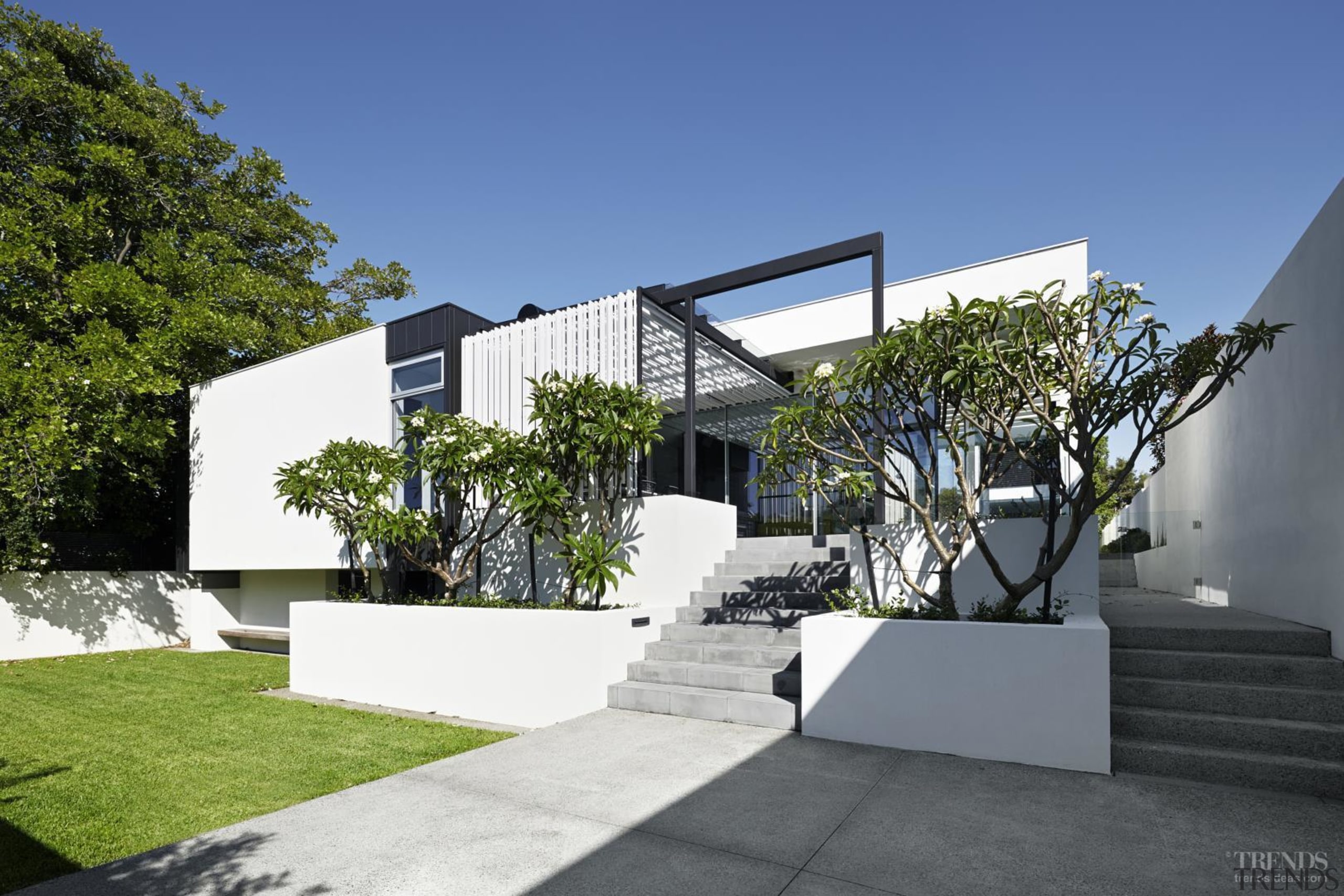 Pathways down both sides of this house provide architecture, building, condominium, elevation, facade, home, house, property, real estate, residential area, villa, blue