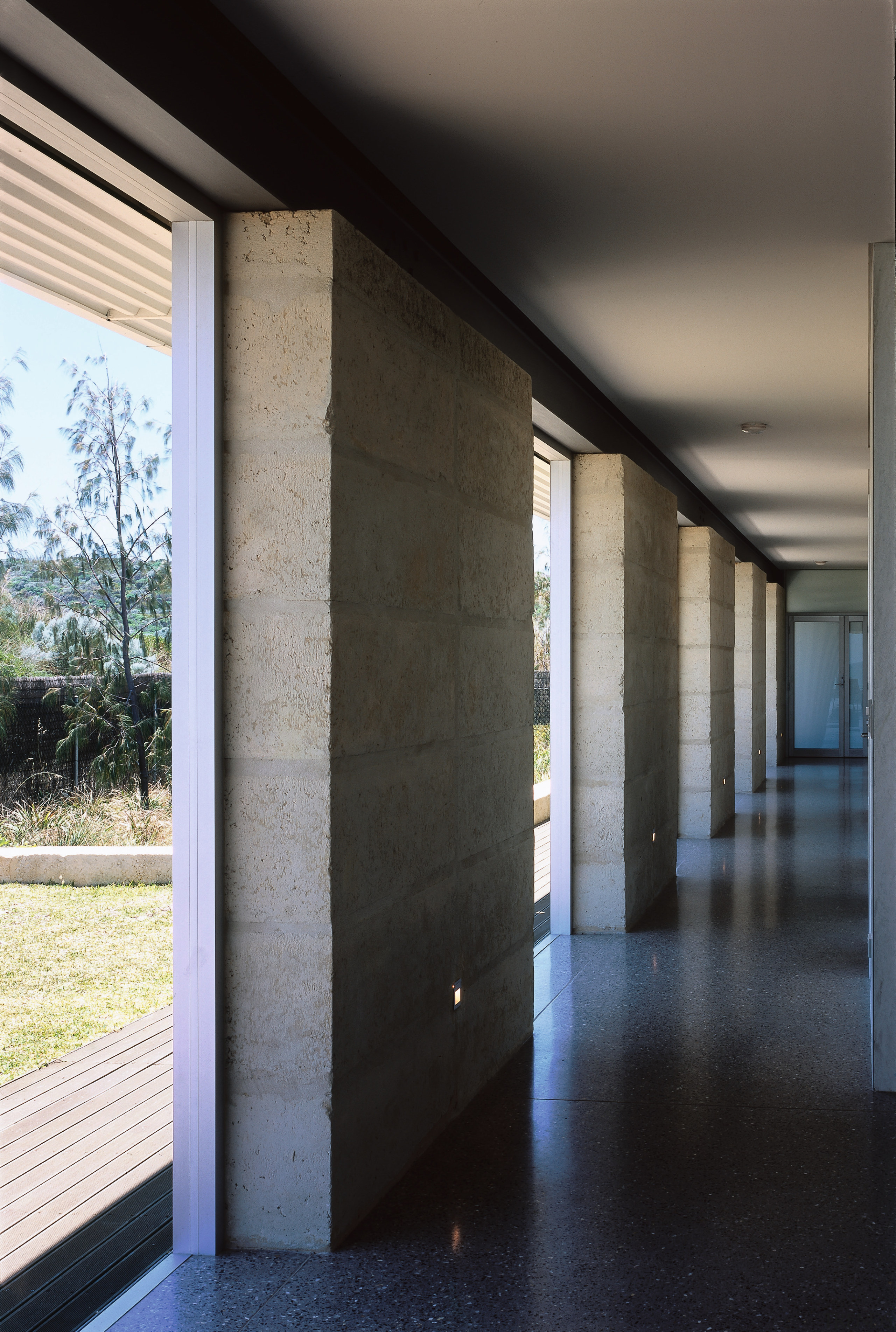 A view of the interior of the home. apartment, architecture, column, daylighting, glass, house, interior design, structure, wall, window, black, gray