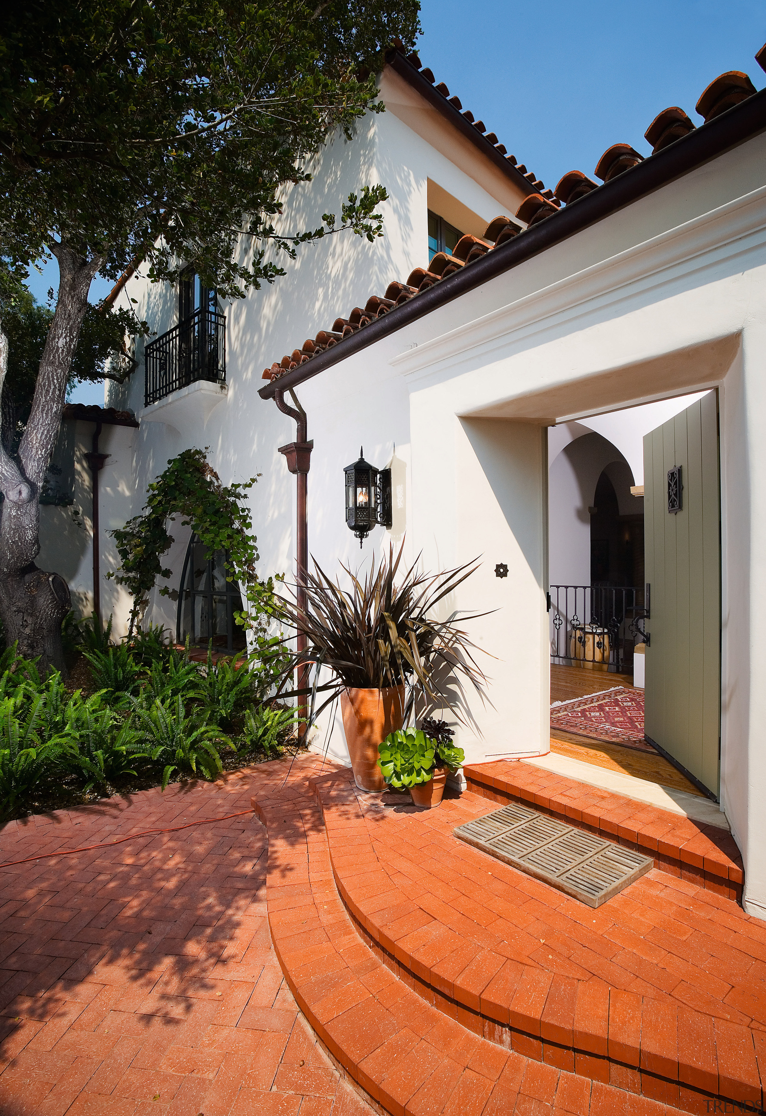 The entry courtyard acts as a transition space courtyard, estate, facade, hacienda, home, house, outdoor structure, property, real estate, residential area, villa, window