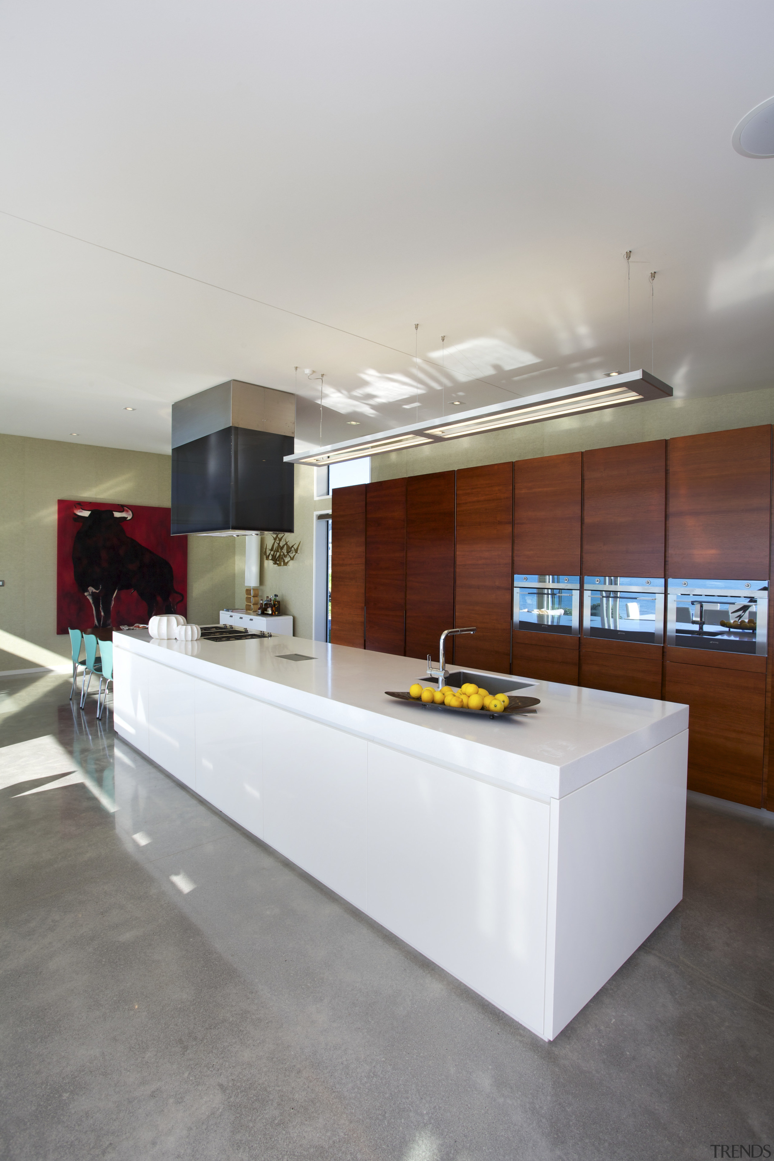 Timber cabinets conceal storage, a bar and fridge-freezer. architecture, countertop, floor, house, interior design, kitchen, gray, white