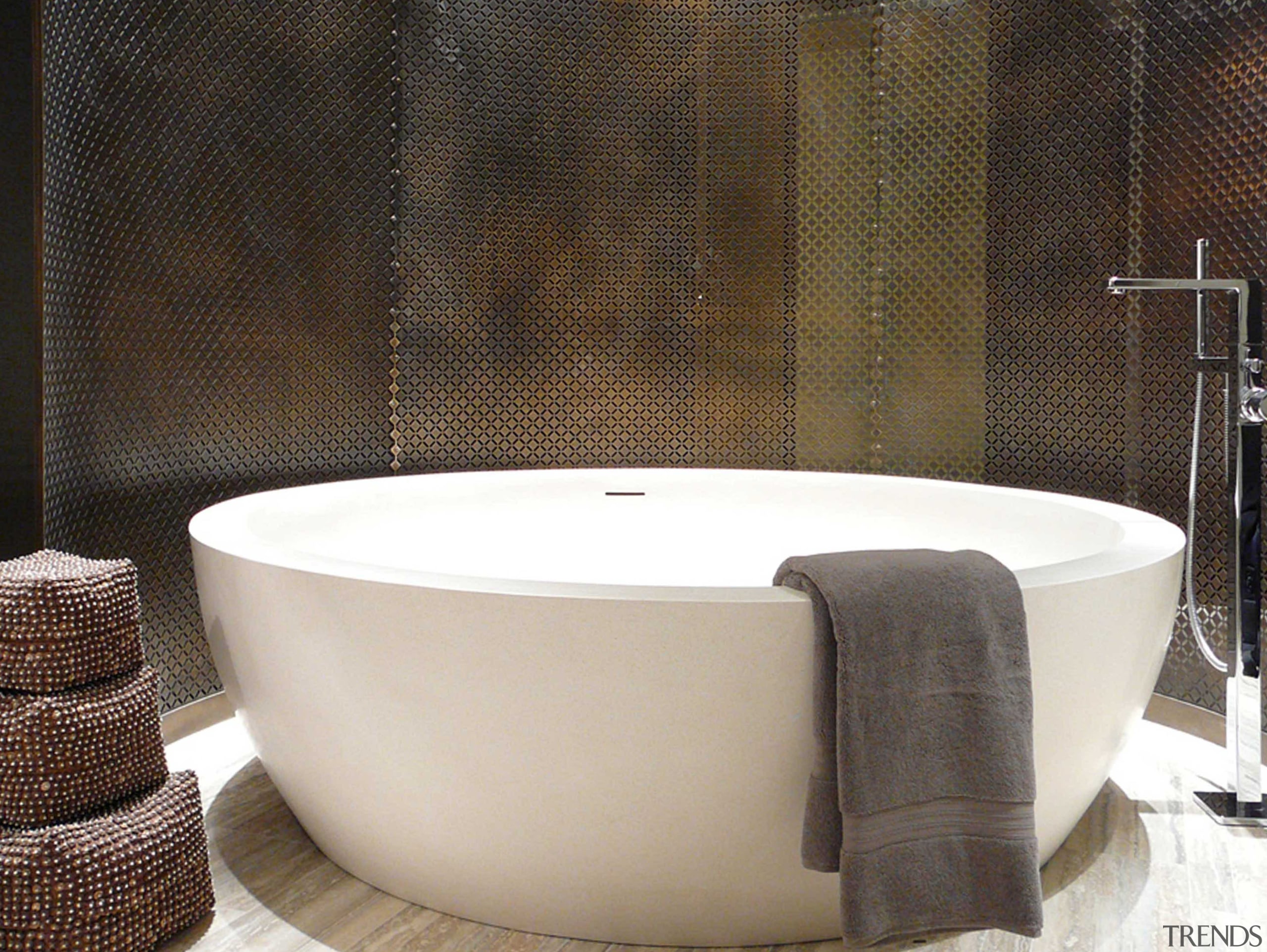 View of a bathroom which features a freestanding angle, bathroom sink, bathtub, ceramic, floor, plumbing fixture, product design, toilet seat, brown, black, white