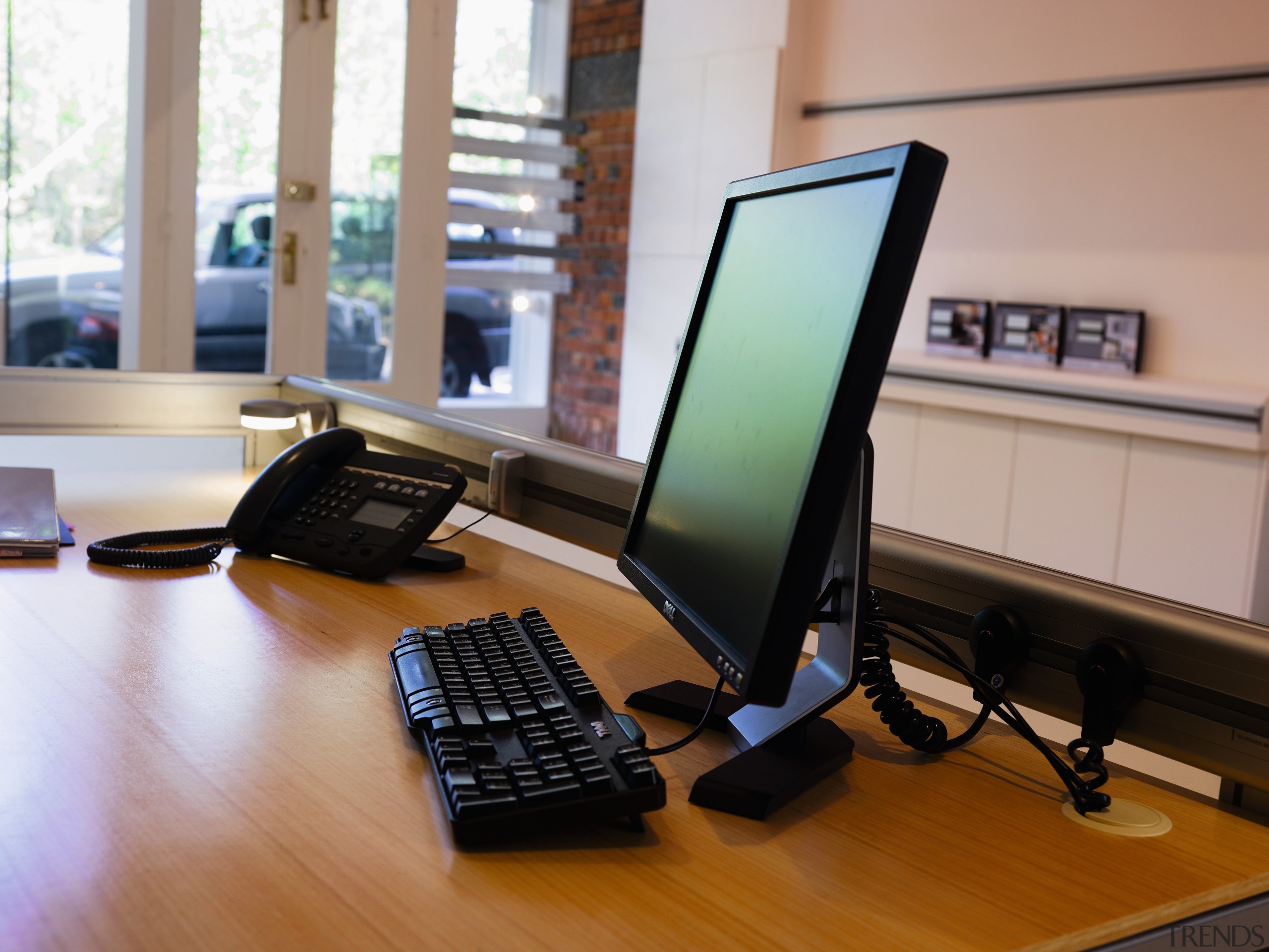 A view of a power track by Eubiq. computer monitor, desk, desktop computer, display device, electronic device, furniture, laptop, netbook, office, personal computer, technology, gray