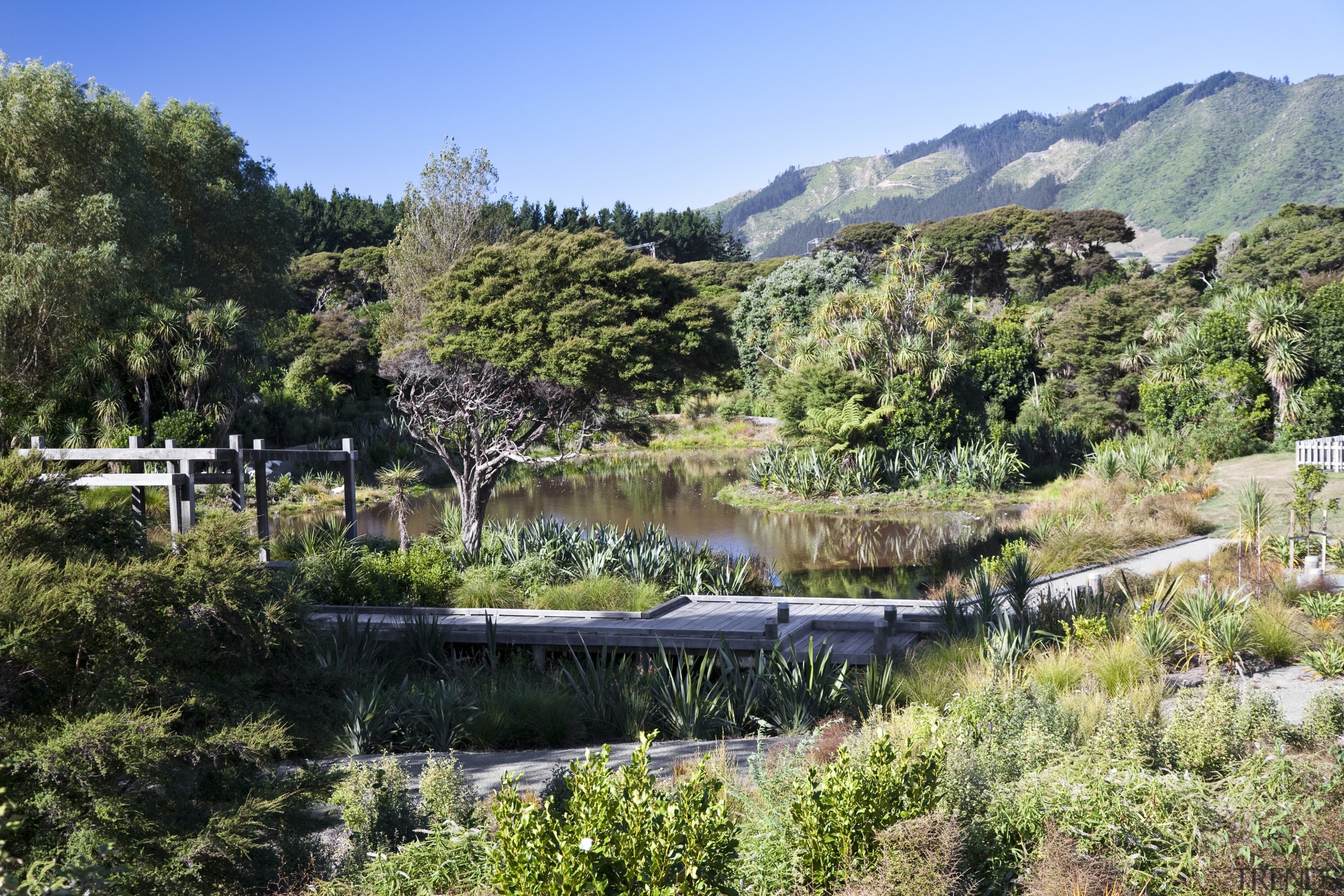 View of surrounding landscape of a energy-efficient development. biome, botanical garden, lake, landscape, mountain, nature, nature reserve, plant, pond, reflection, reservoir, riparian zone, tree, vegetation, water, water resources, watercourse, wilderness