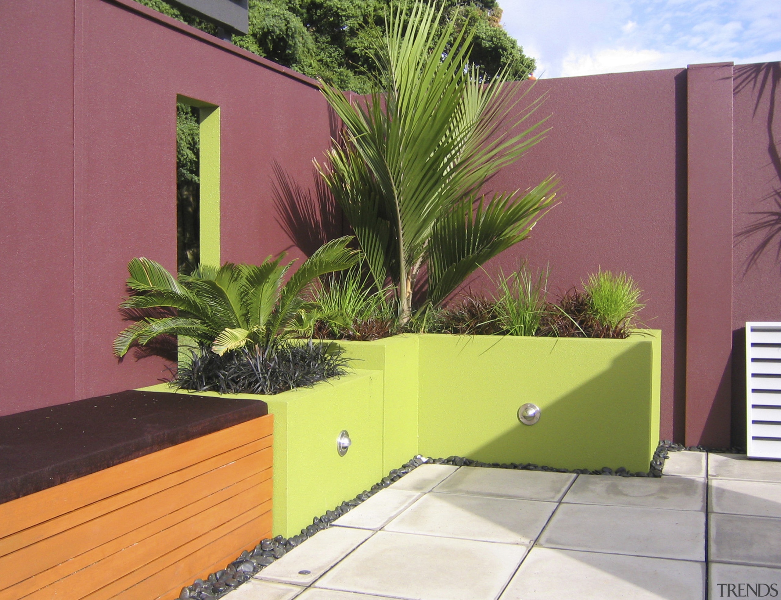 A view of the Panelrock modular wall system arecales, backyard, courtyard, facade, fence, grass, house, landscaping, palm tree, plant, property, real estate, wall, yard, red