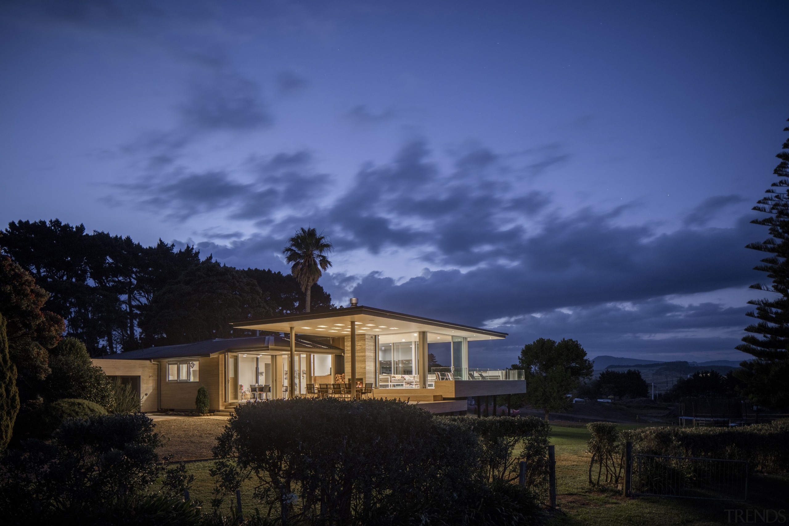 This substantial renovation of a lakeside home by architecture, atmosphere, cloud, cottage, darkness, dawn, dusk, estate, evening, farmhouse, highland, home, horizon, house, landscape, lighting, mansion, meteorological phenomenon, morning, nature, night, phenomenon, property, real estate, residential area, rural area, sky, sunlight, tree, blue, black