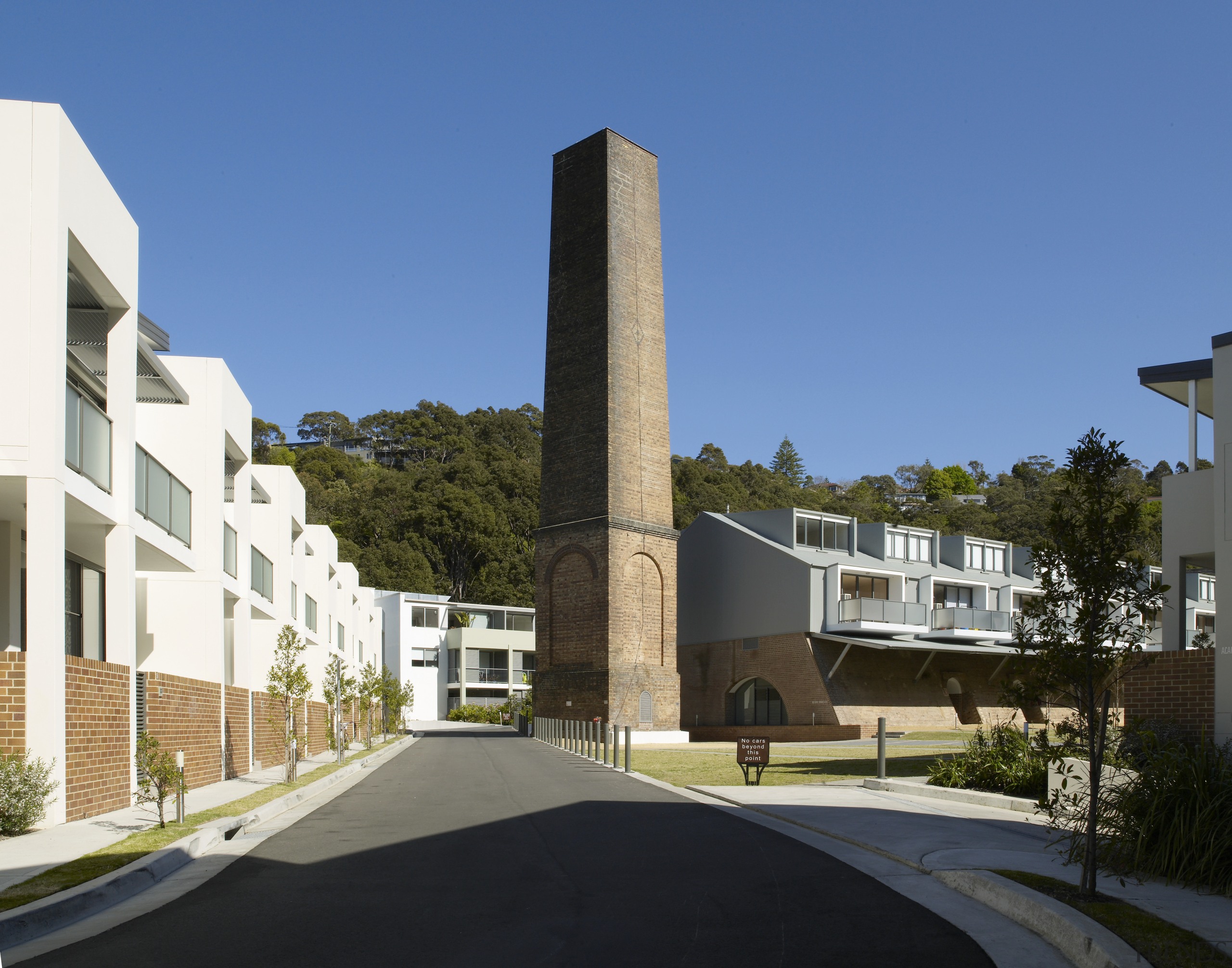 The towering brick chimney is one of the architecture, building, condominium, corporate headquarters, house, mixed use, neighbourhood, property, real estate, residential area, sky, teal