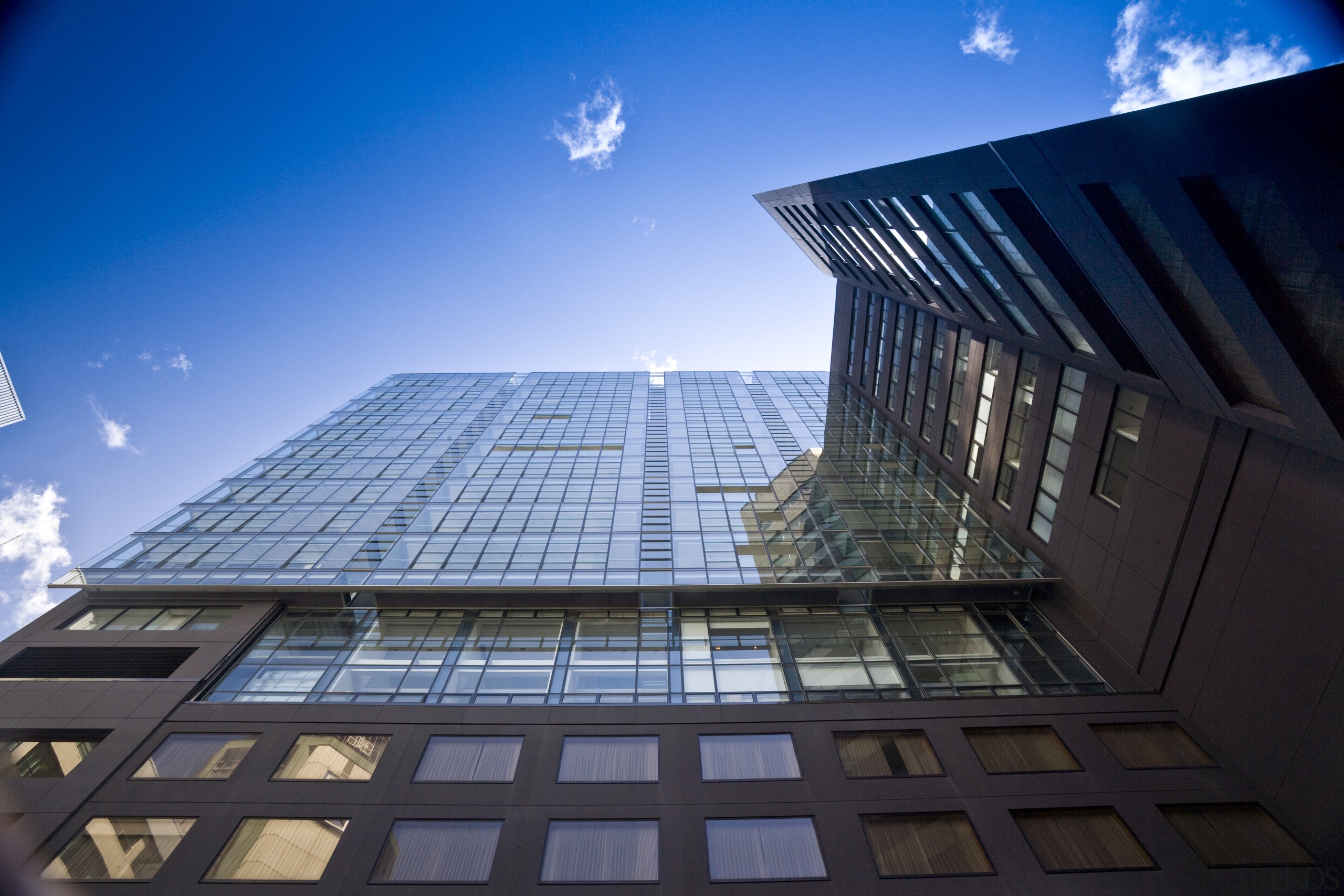 Exterior view of the apartments in Auckland CBD architecture, building, condominium, corporate headquarters, daylighting, daytime, facade, headquarters, landmark, metropolis, metropolitan area, reflection, sky, skyscraper, structure, sunlight, symmetry, urban area, black, blue, teal