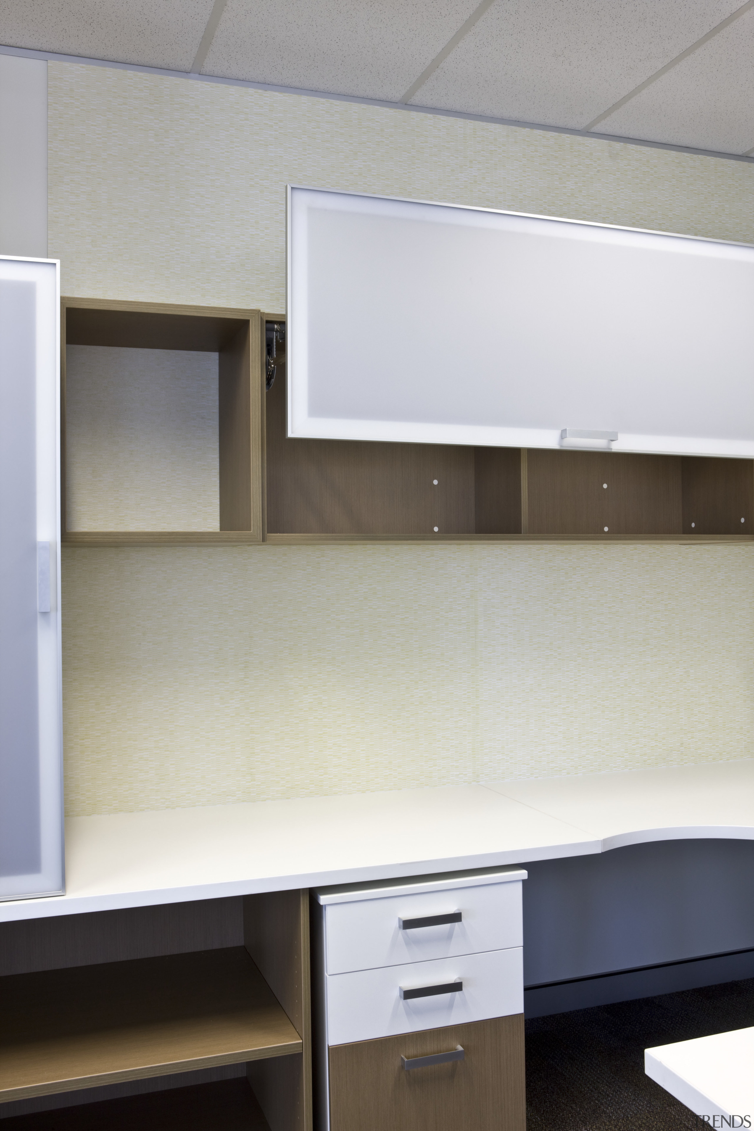 Interior view of an office which includes office cabinetry, countertop, desk, furniture, interior design, kitchen, office, product design, shelf, shelving, gray