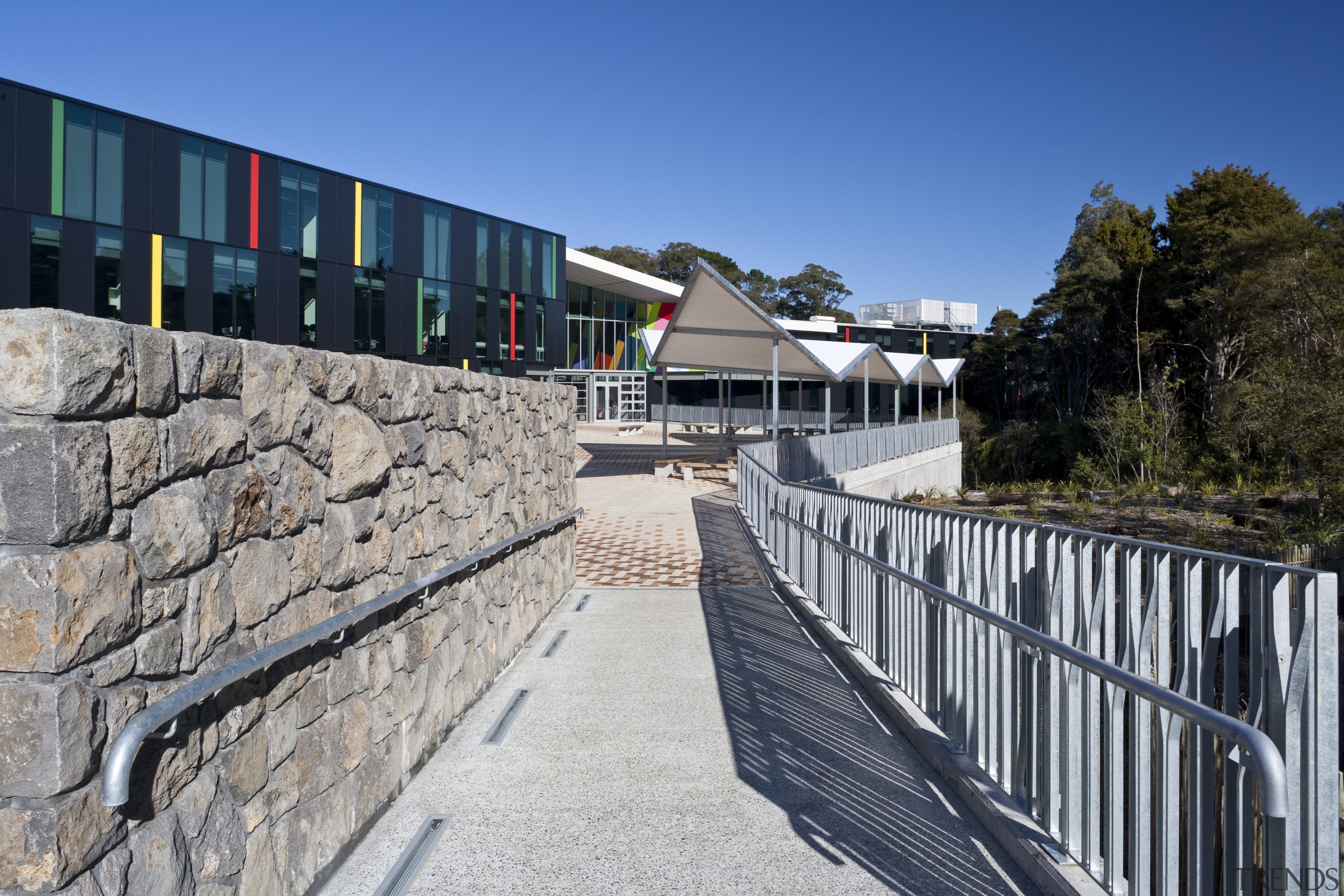 Exterior view of a concrete pathway at Albany architecture, building, facade, house, real estate, sky, structure, tree, walkway, wall, gray