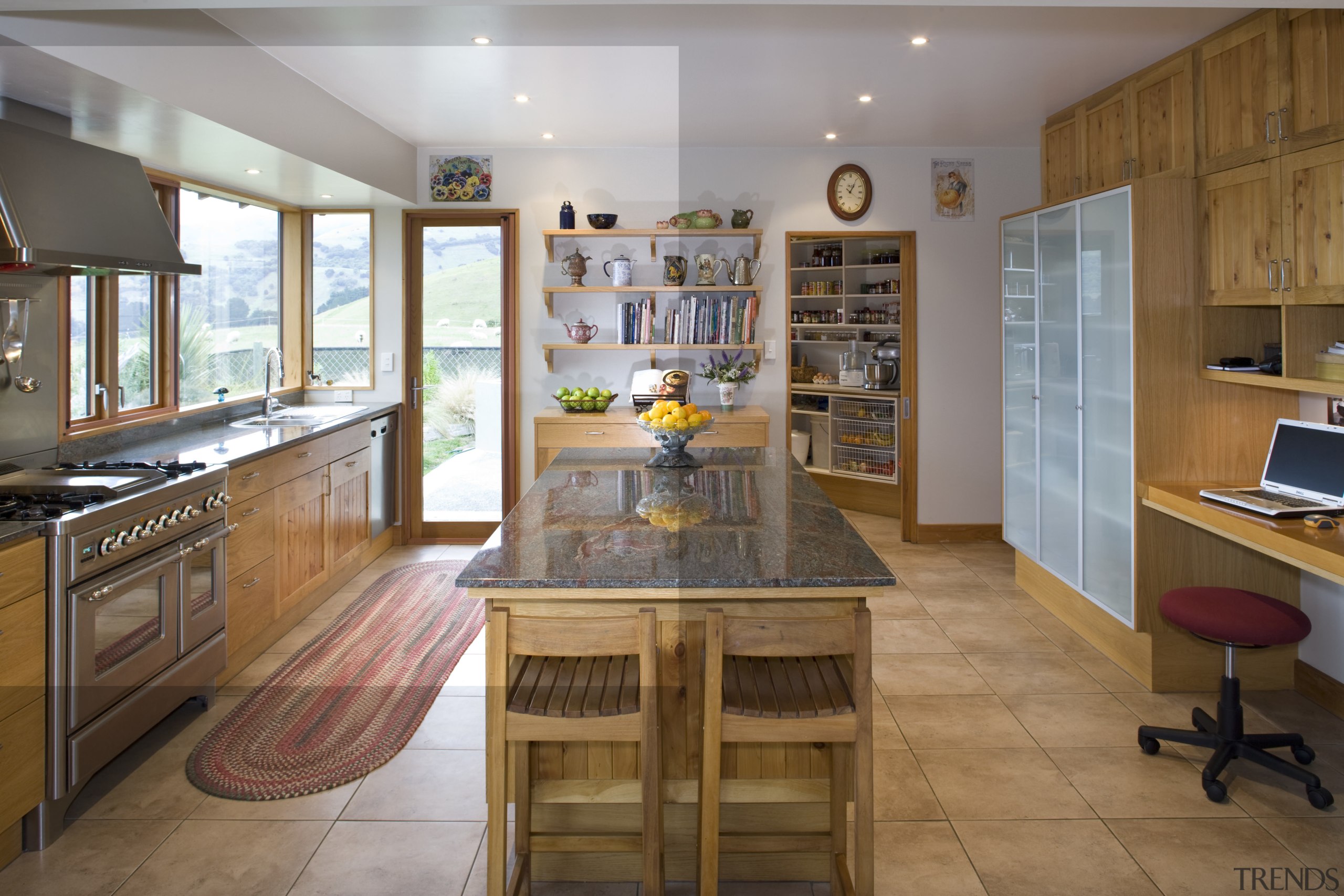 Dispaly shelves are placed above the cabinets next cabinetry, countertop, cuisine classique, flooring, interior design, kitchen, real estate, room, brown, gray