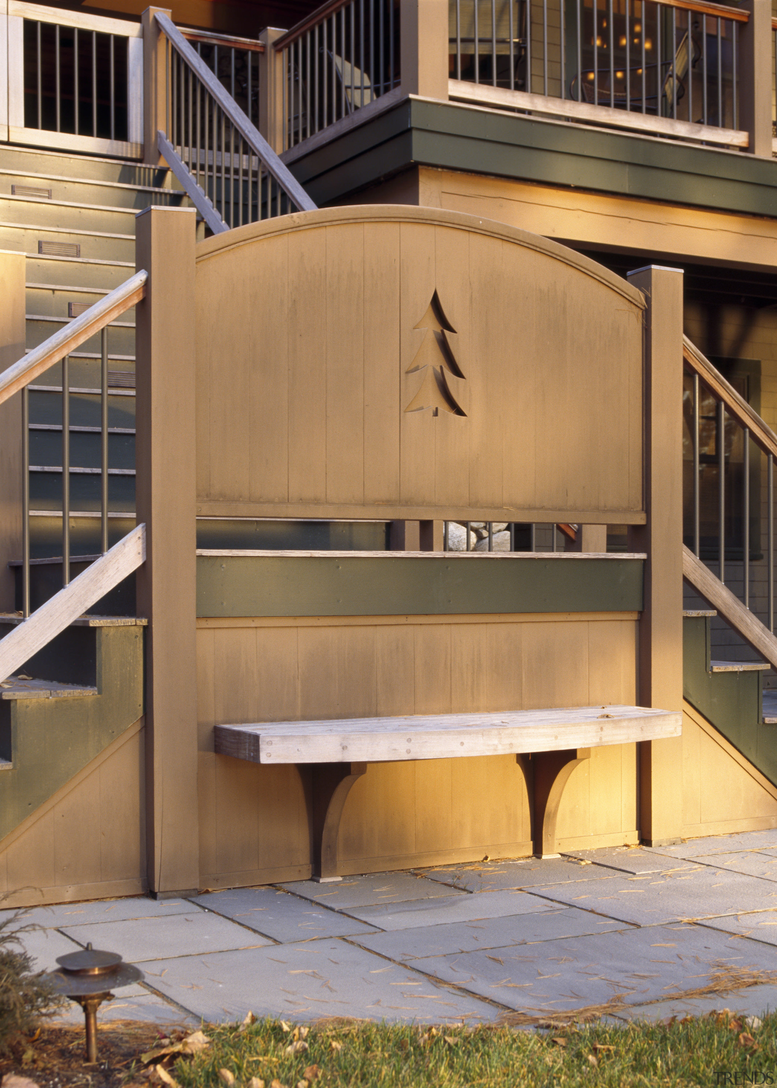 View of the holiday homes exterior featuring white architecture, deck, facade, furniture, handrail, home, stairs, wood, orange, brown