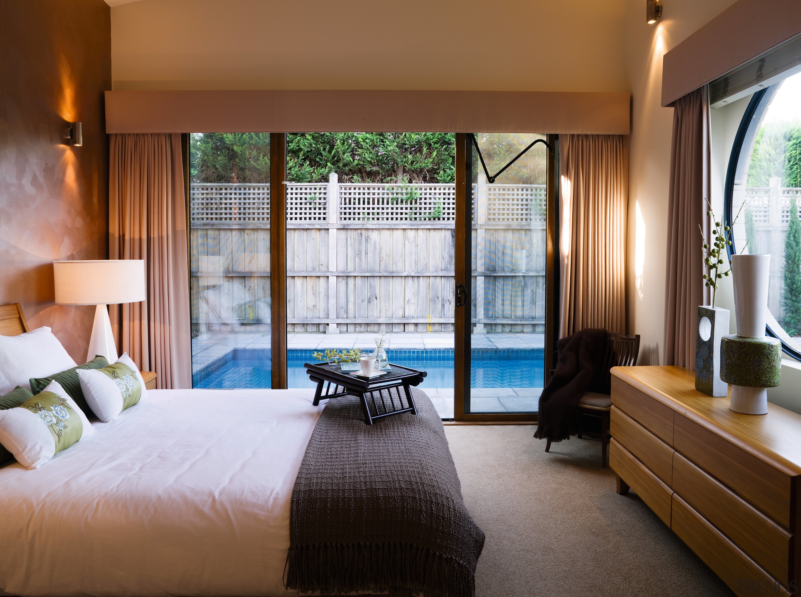 A view of this bedroom featuring carpet flooring, bedroom, ceiling, hotel, interior design, real estate, room, suite, window, window covering, window treatment, brown