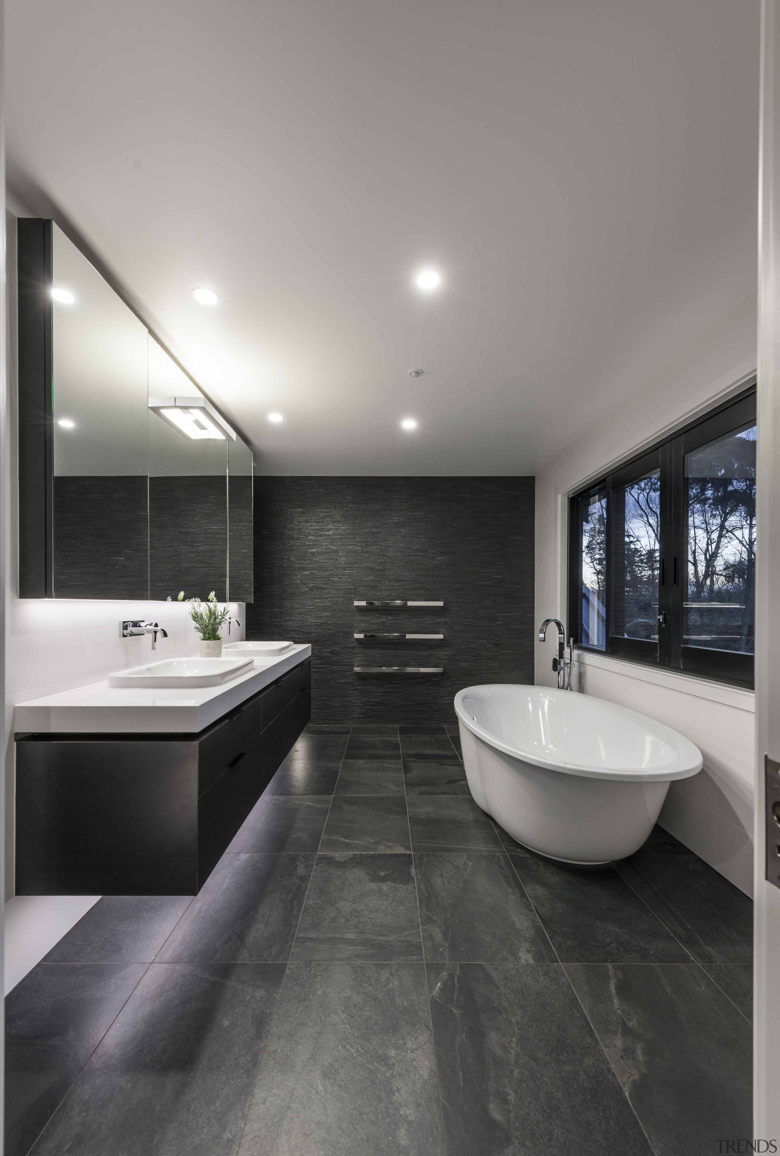 The tub is on show on entering this architecture, bathroom, ceiling, countertop, floor, flooring, house, interior design, real estate, room, sink, tile, wall, wood flooring, gray, black