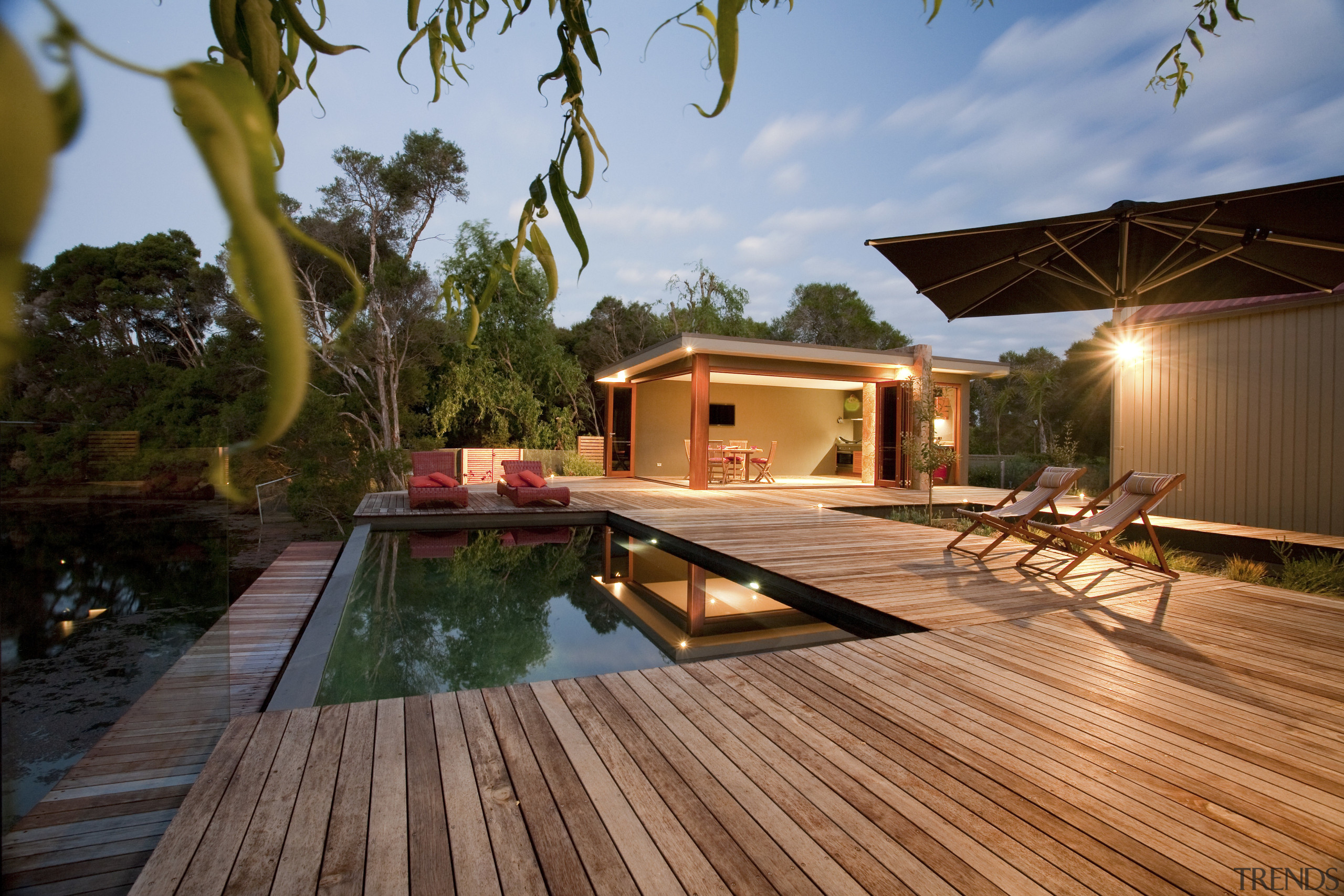 View of pool and patio area. - View architecture, backyard, cottage, deck, estate, home, house, leisure, lighting, outdoor structure, property, real estate, resort, swimming pool, villa, brown